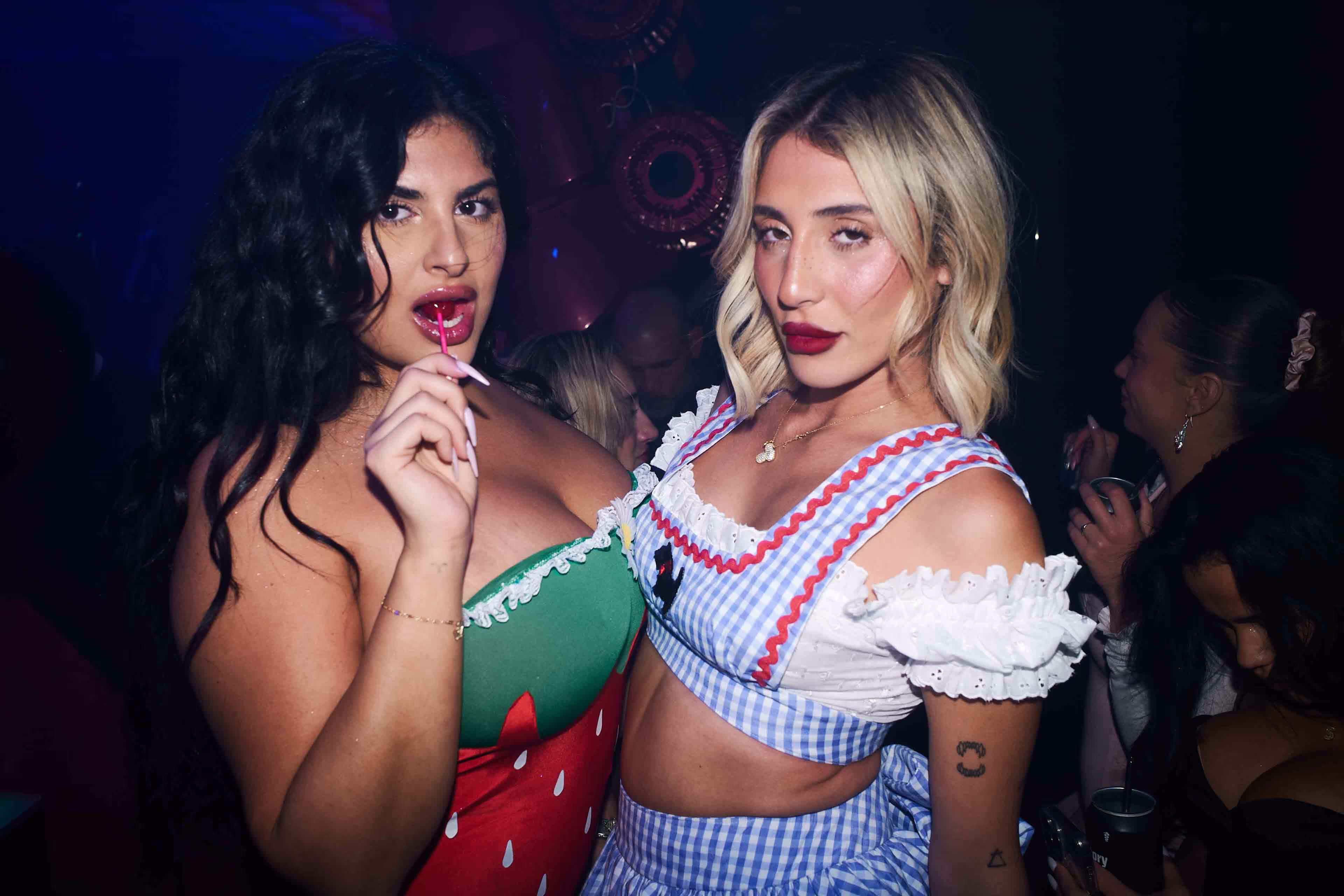 Two beautiful women standing next to each other.