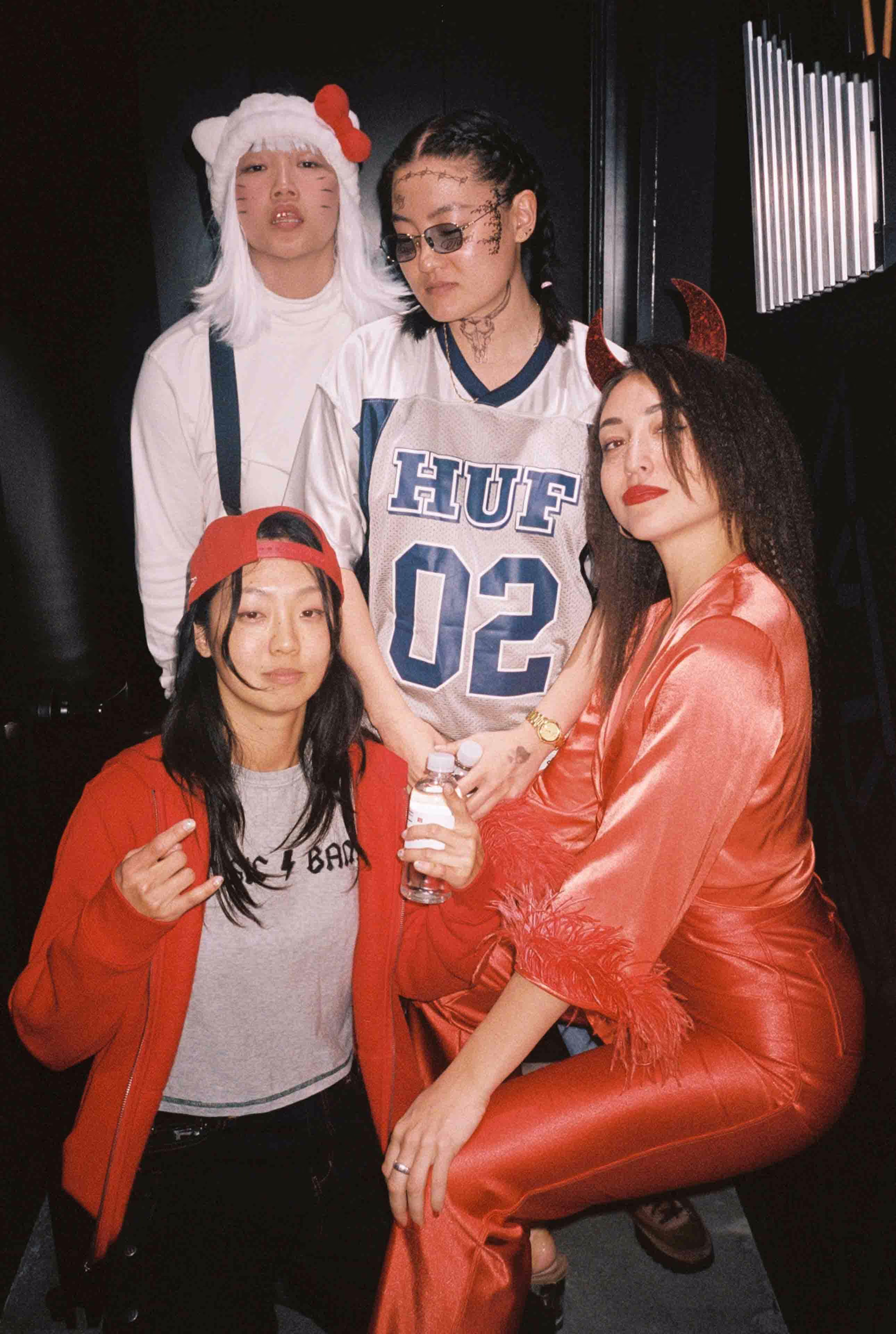 A group of people in costumes posing for a picture.