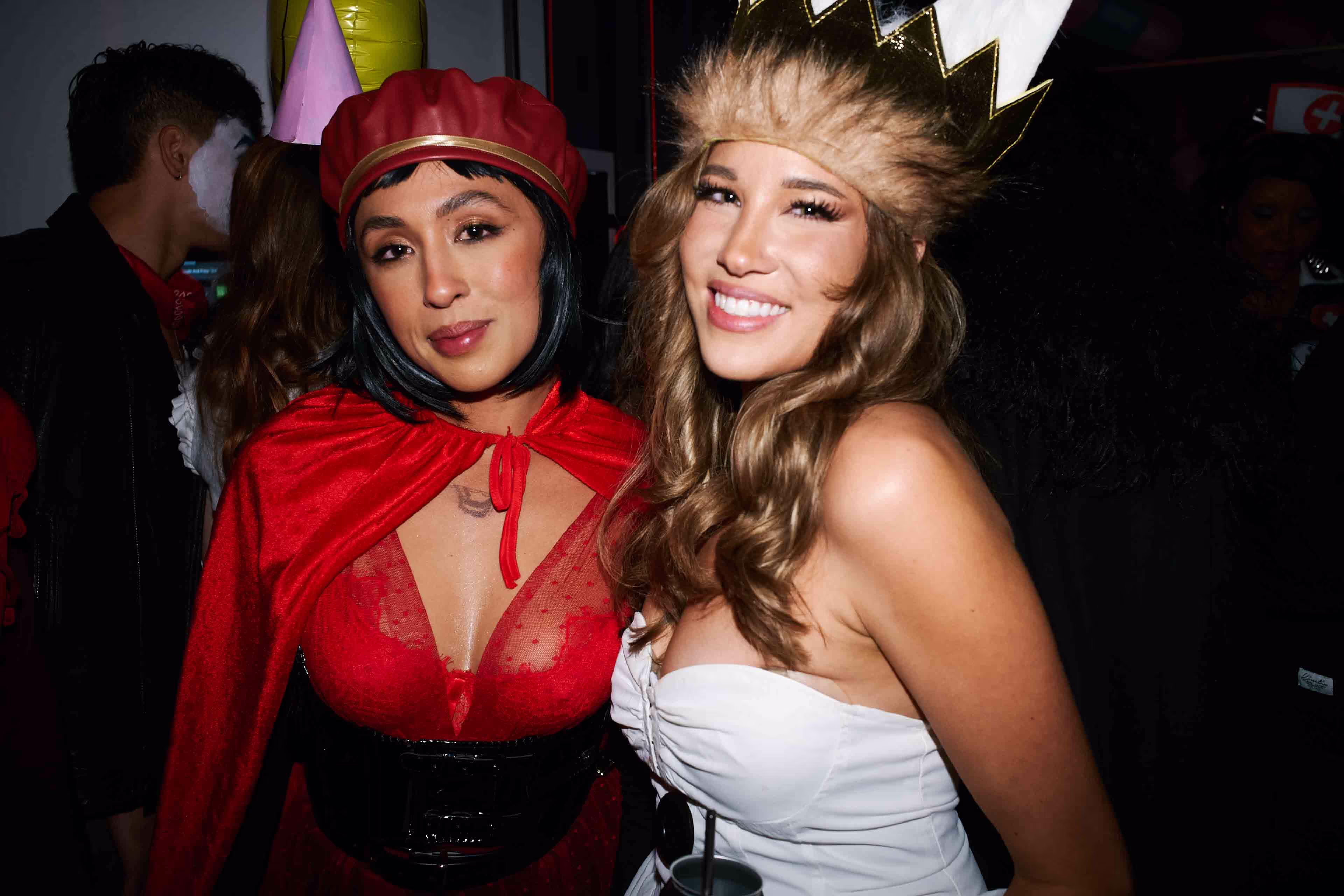 Two women in costumes posing for a picture.