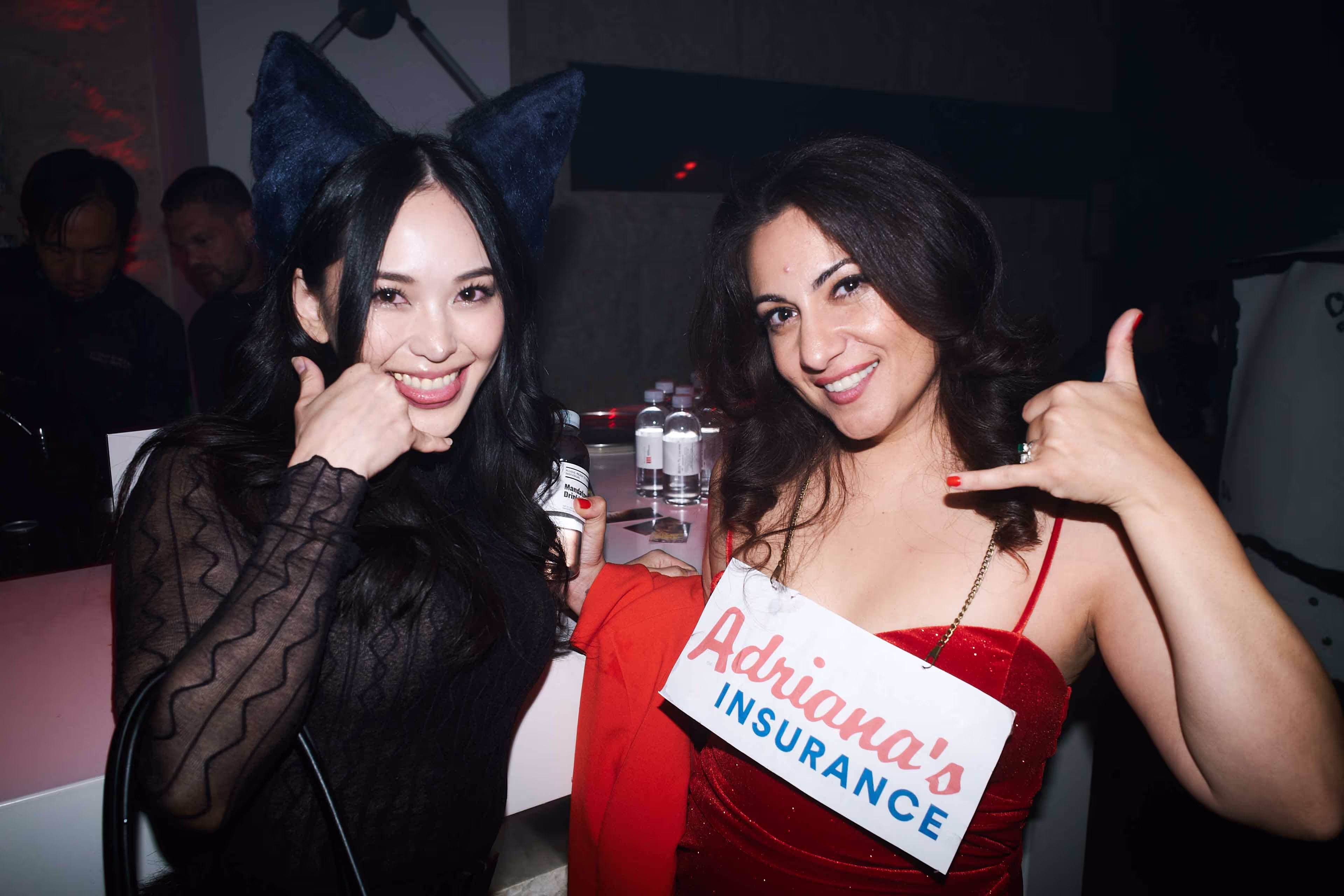 Two beautiful women standing next to each other.