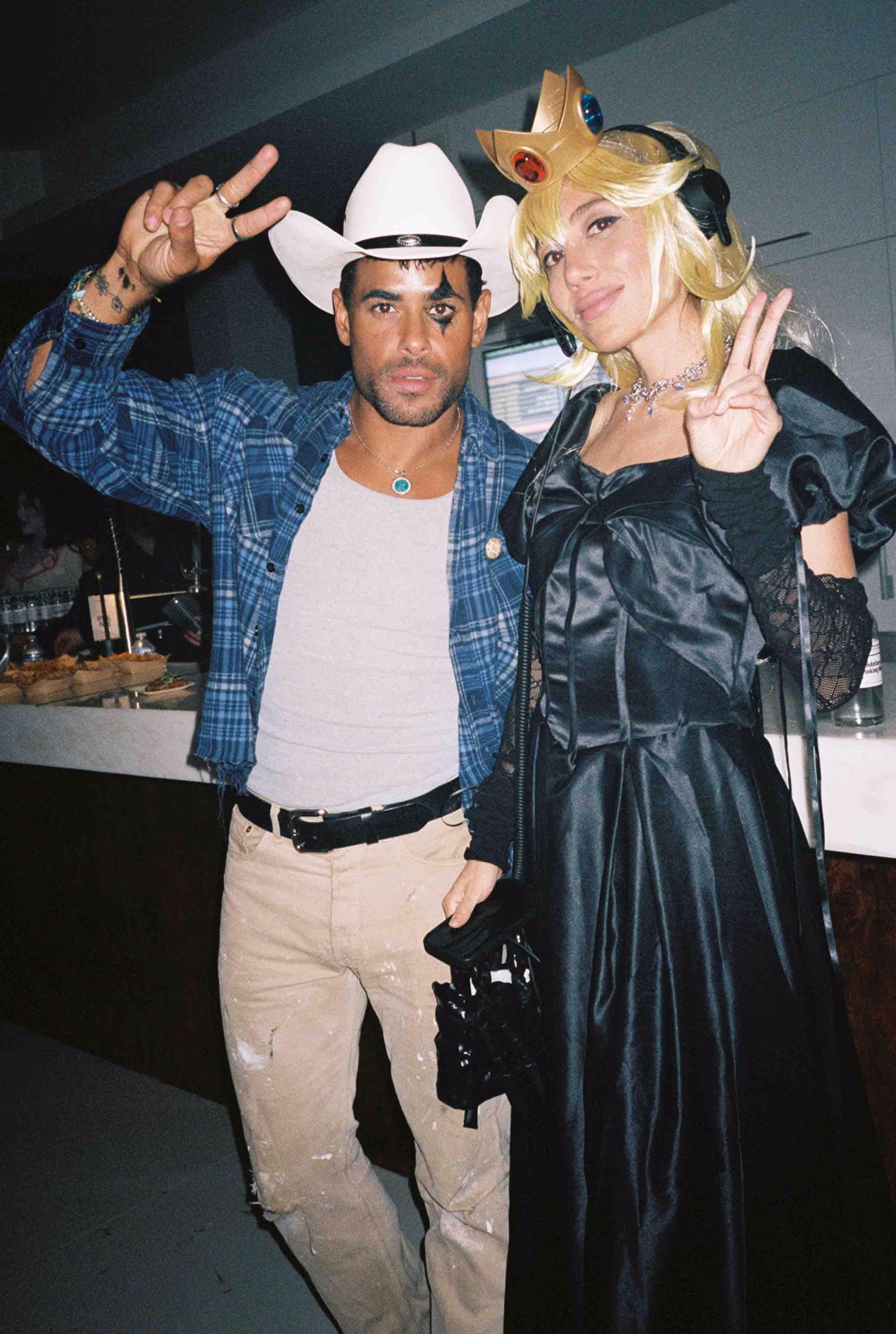 A man in a cowboy hat and a woman in a black dress.