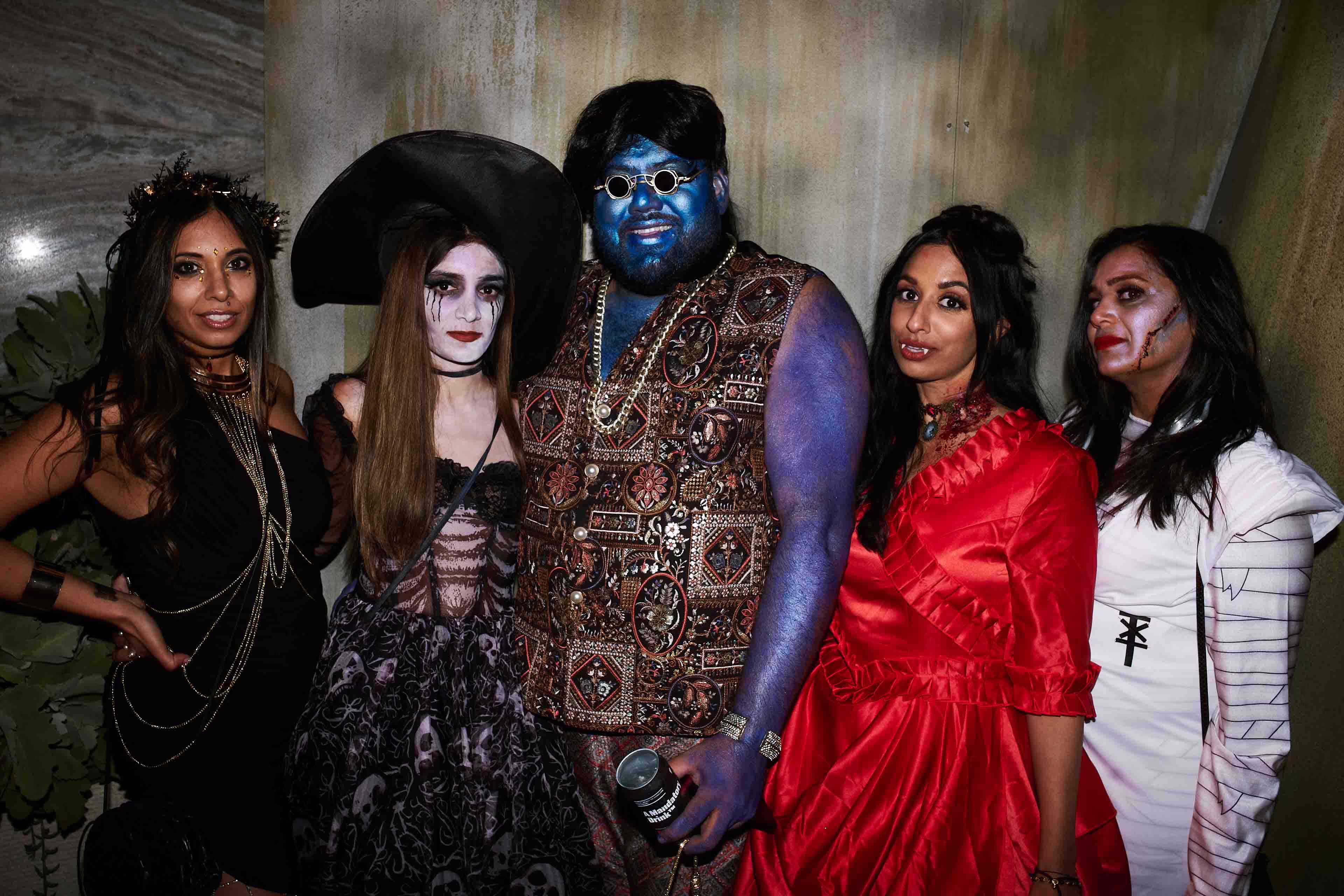 A group of people in costumes posing for a picture.