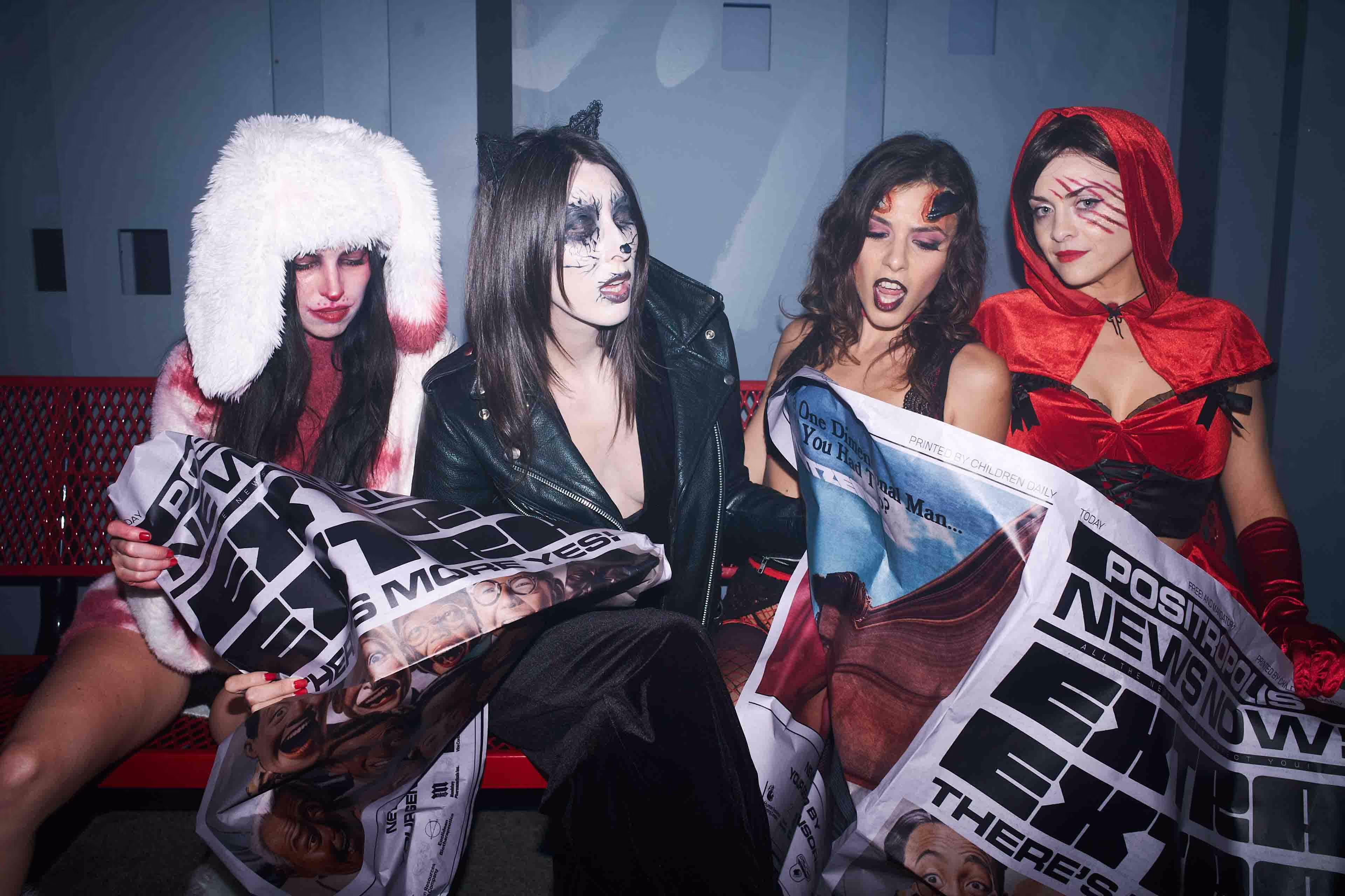 A group of women dressed in costumes posing for a photo.