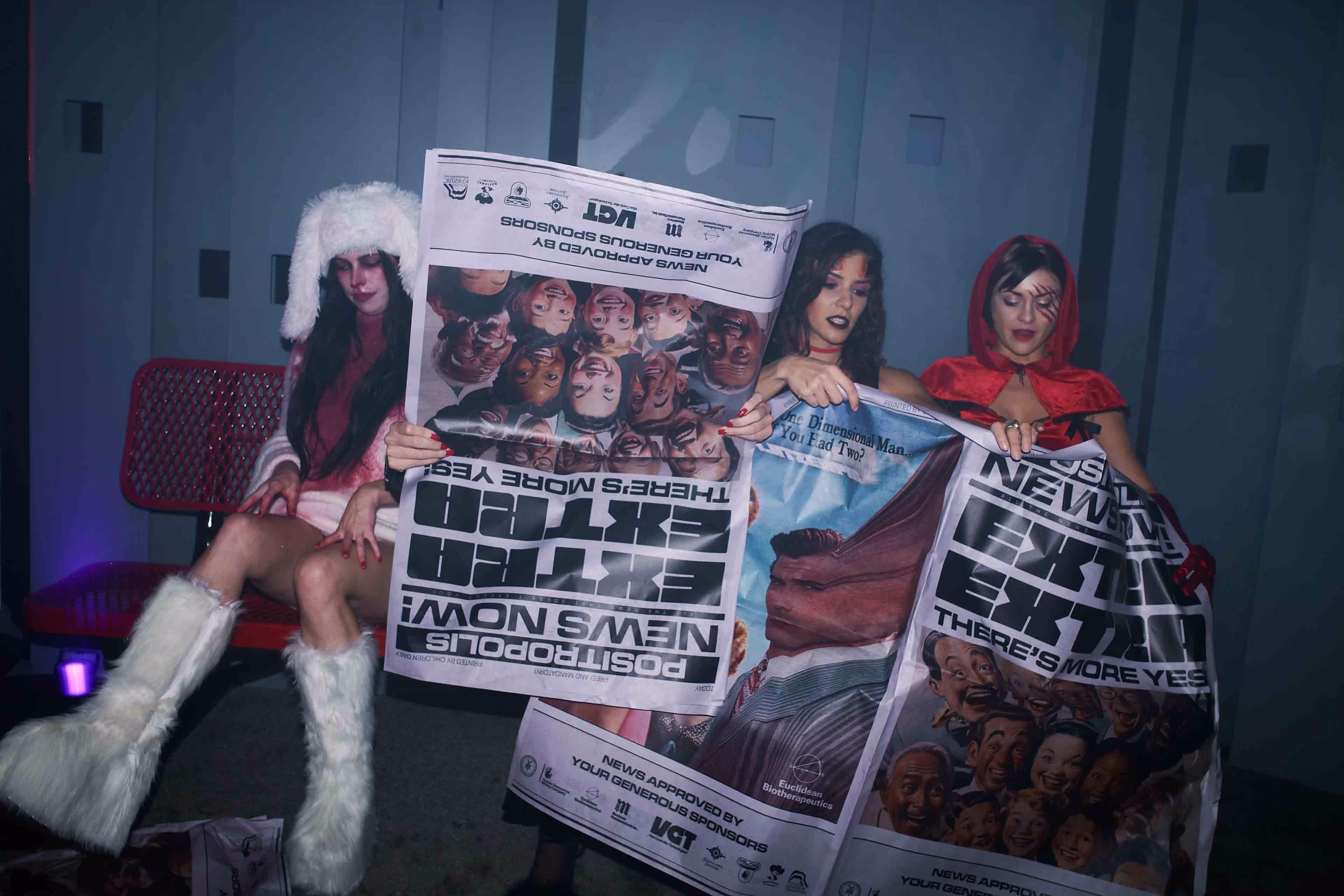 A woman in a costume holding a newspaper.