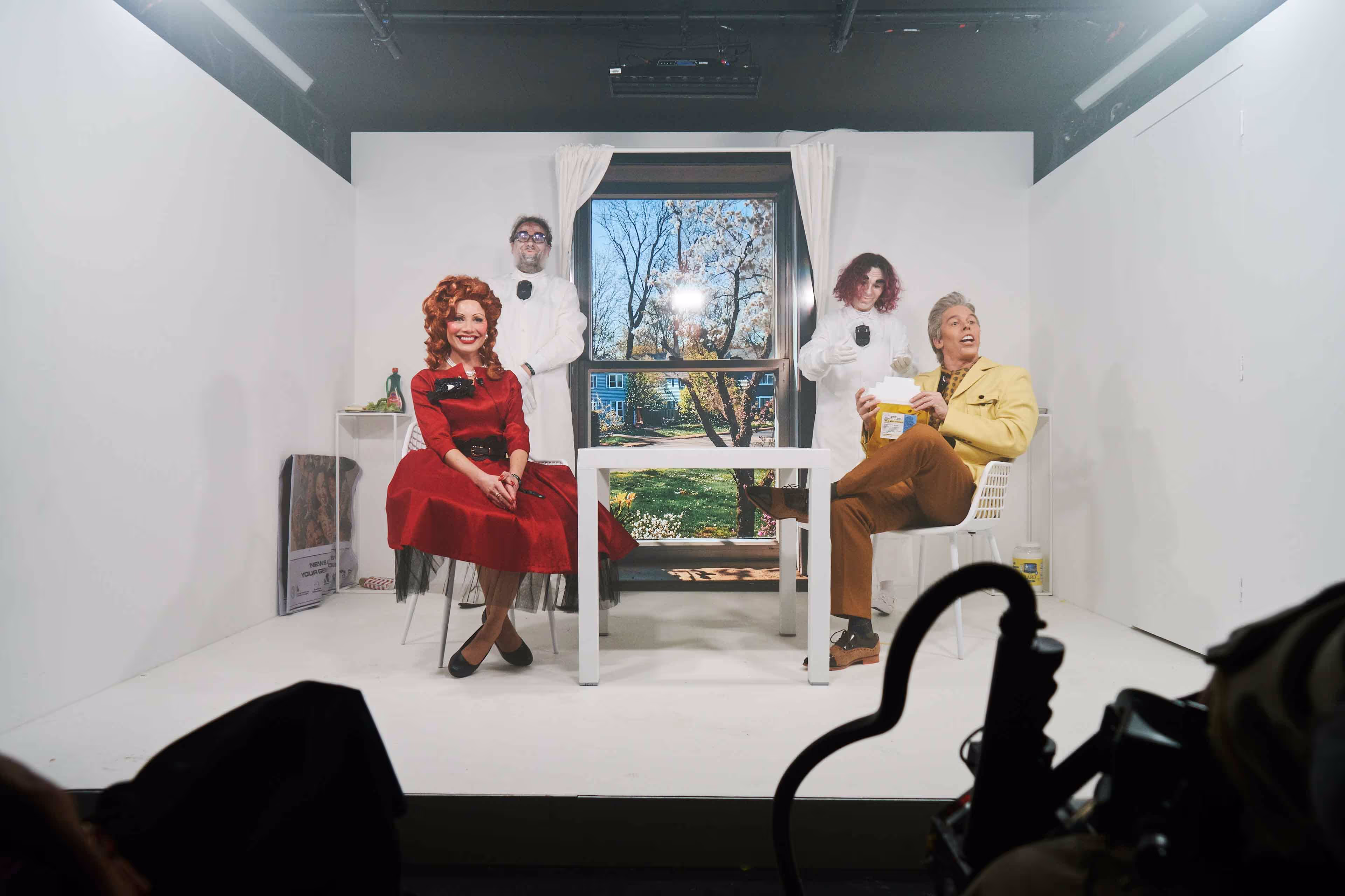 A group of people sitting around a white table.