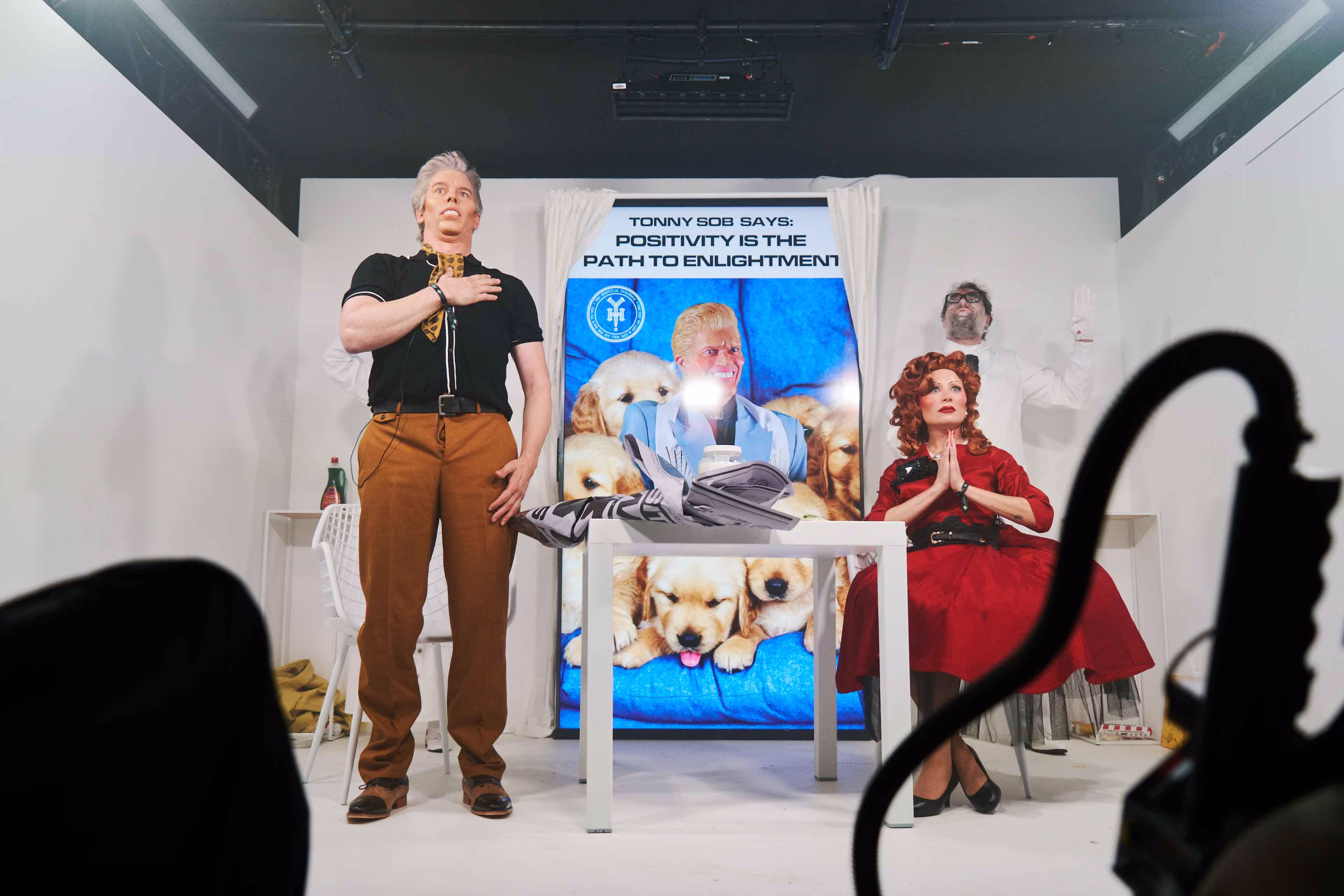 A man standing next to a woman in front of a poster.