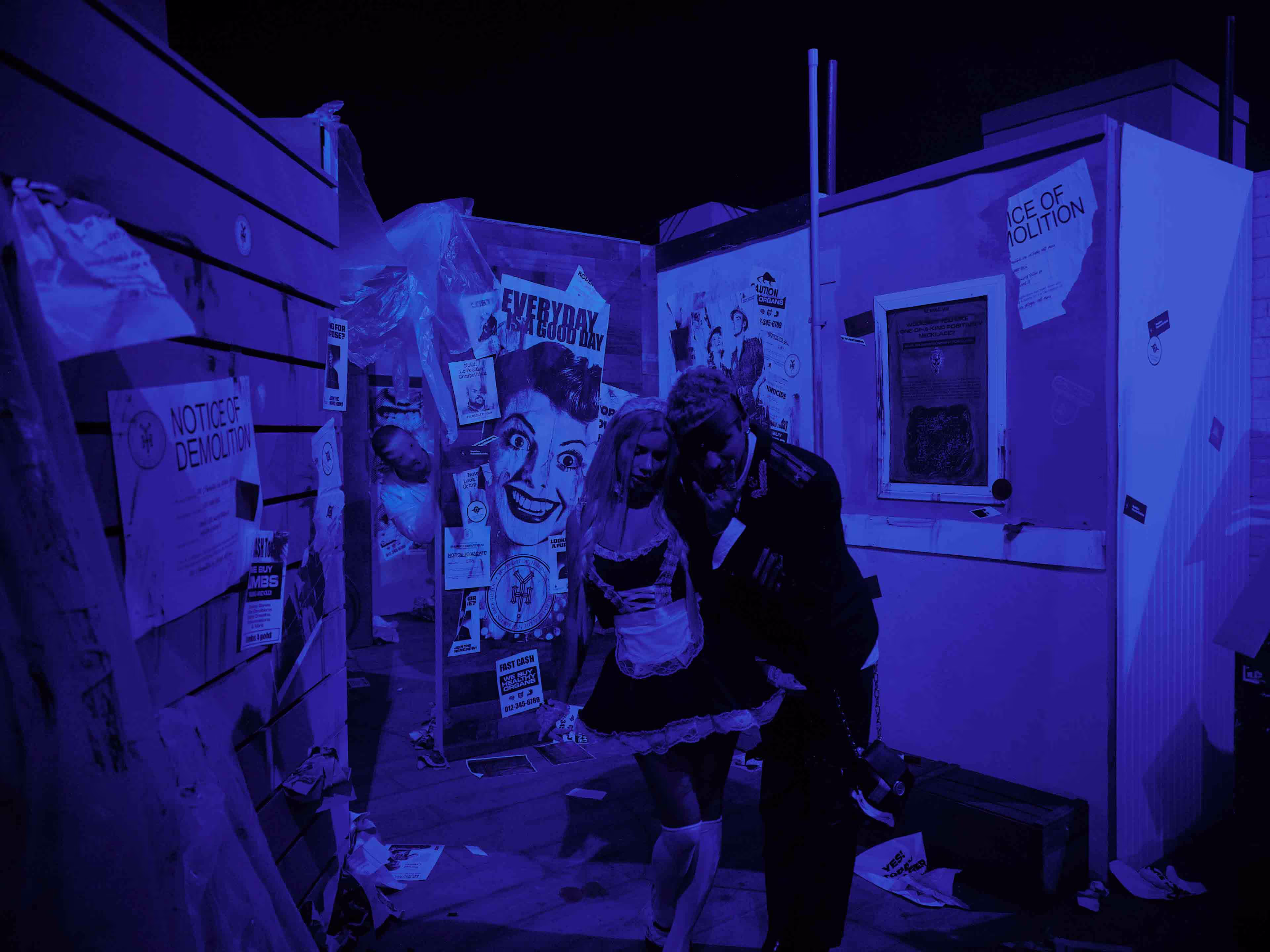 A couple of people that are standing in front of a refrigerator.