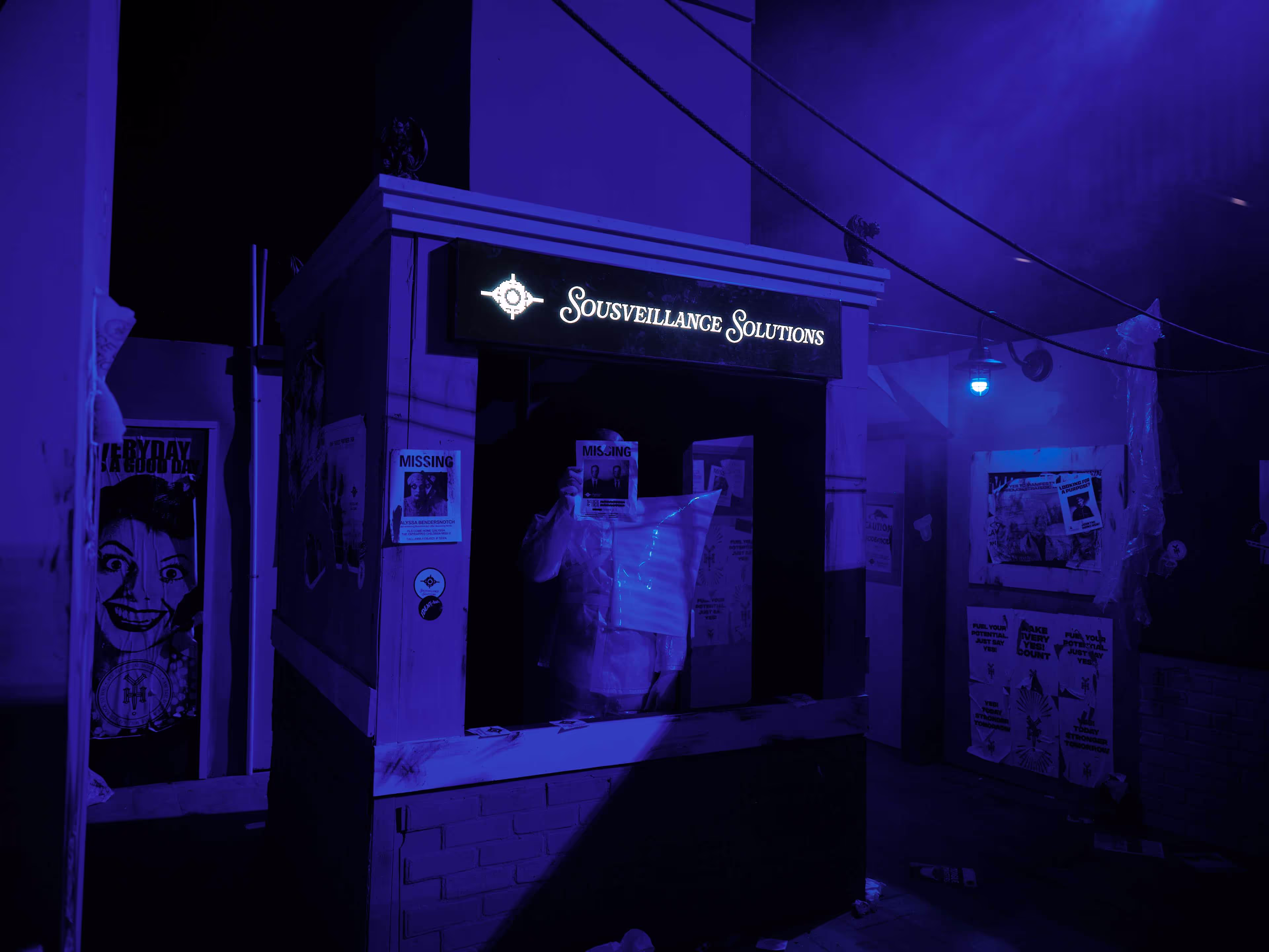 A man standing in front of a purple light.