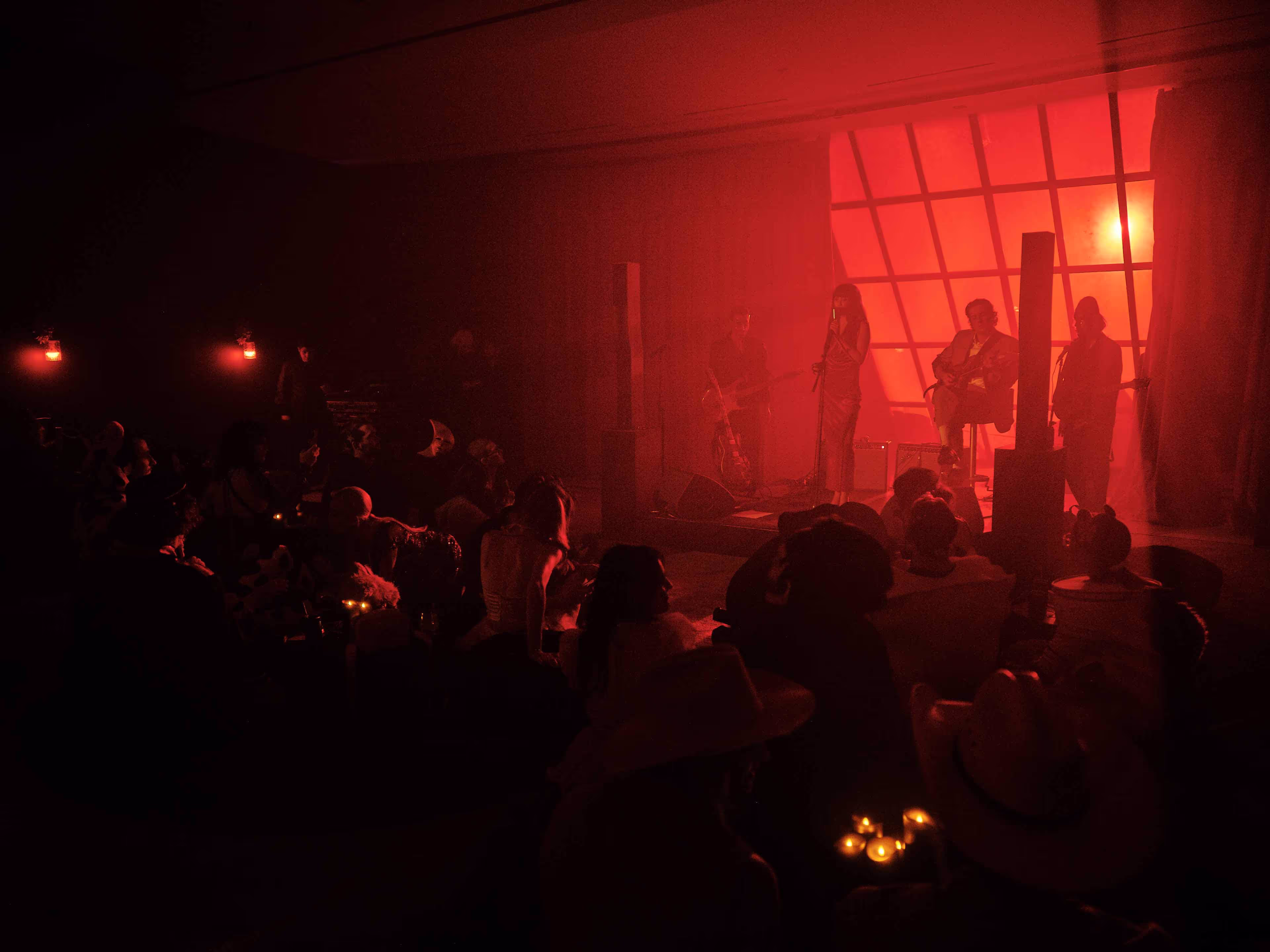 A group of people sitting in a dark room.