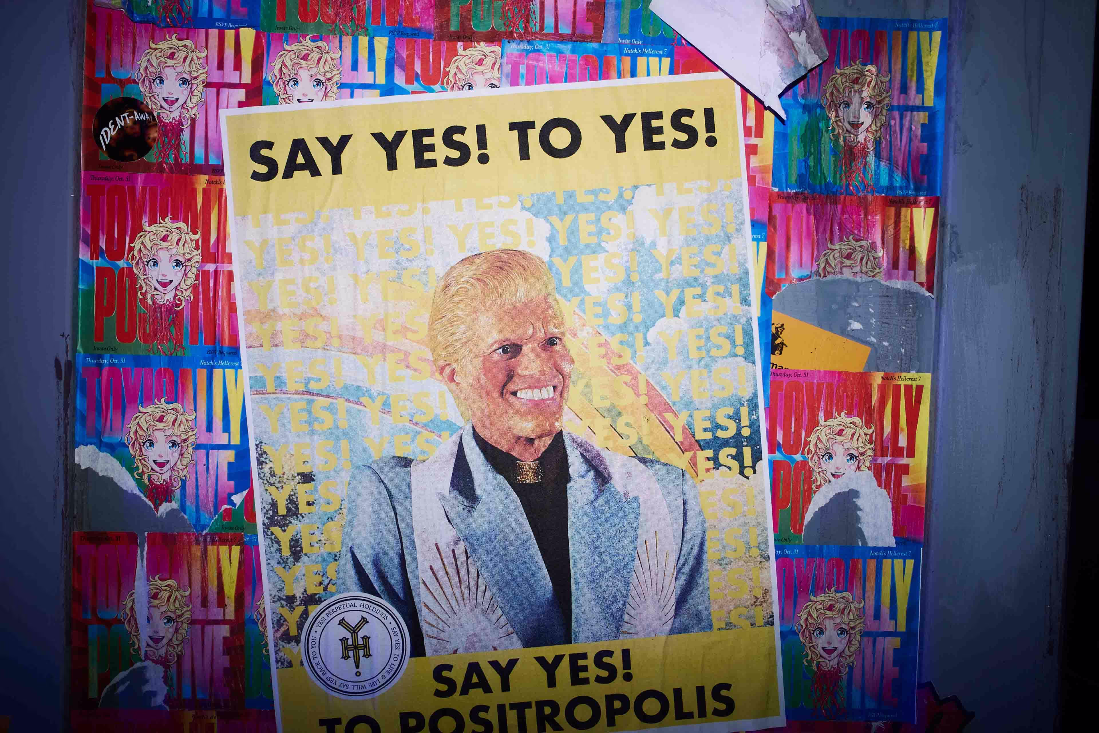 A wall of posters with a picture of a man on it.