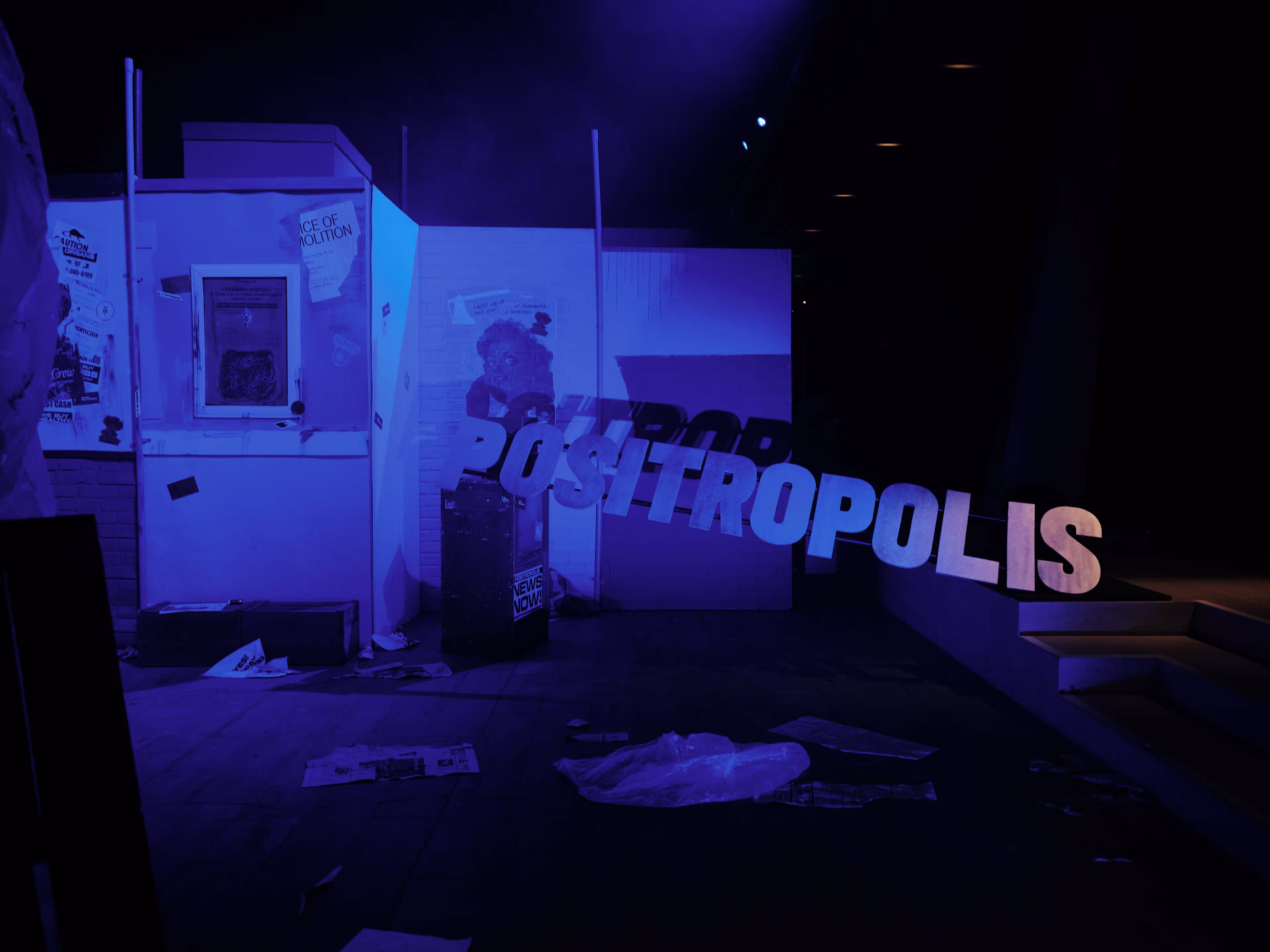 A dark room with a sign that says positropolis.