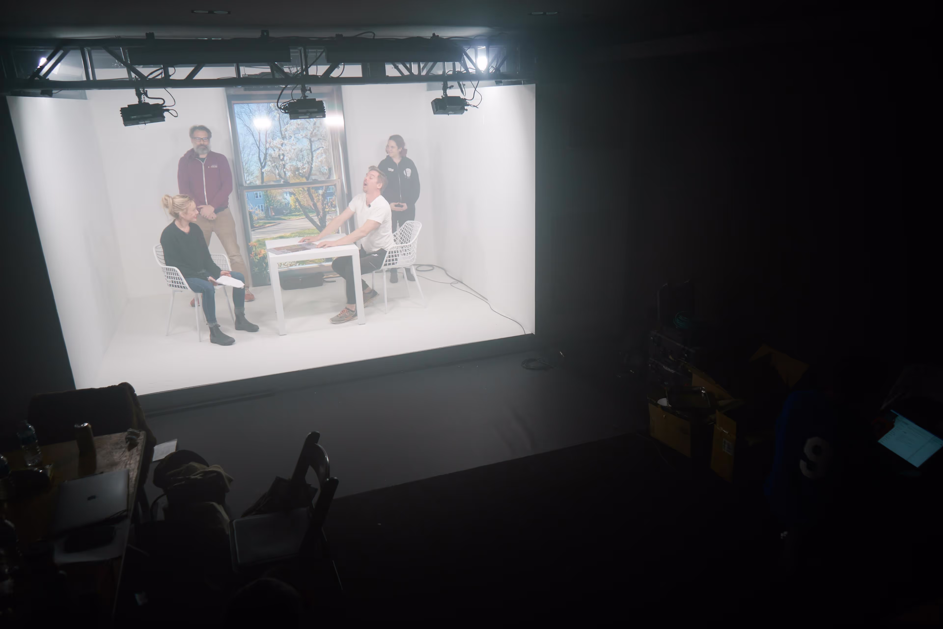 A group of people sitting around a table in a dark room.