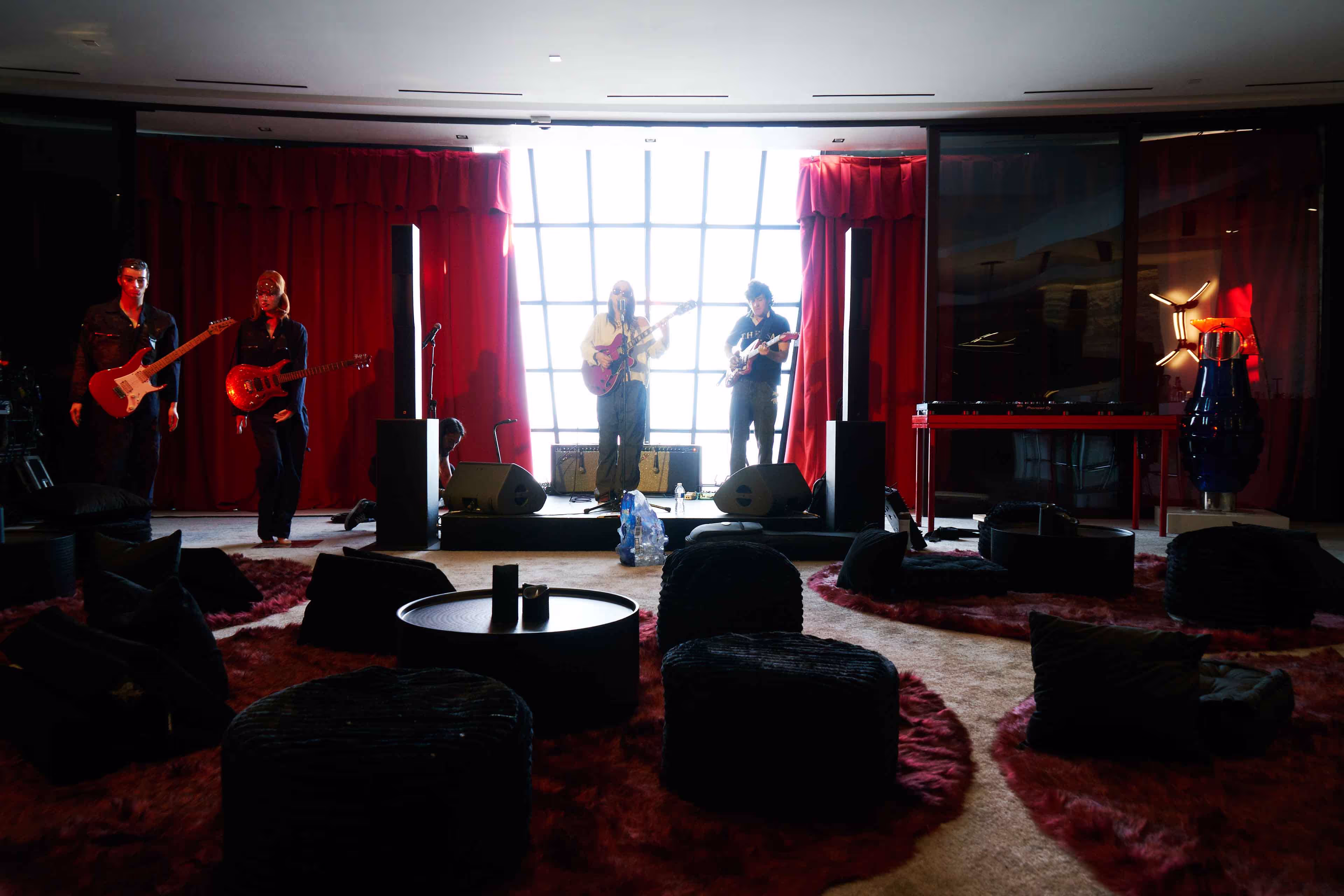 A group of people standing around a living room.