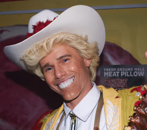 A man wearing a white cowboy hat and yellow shirt.