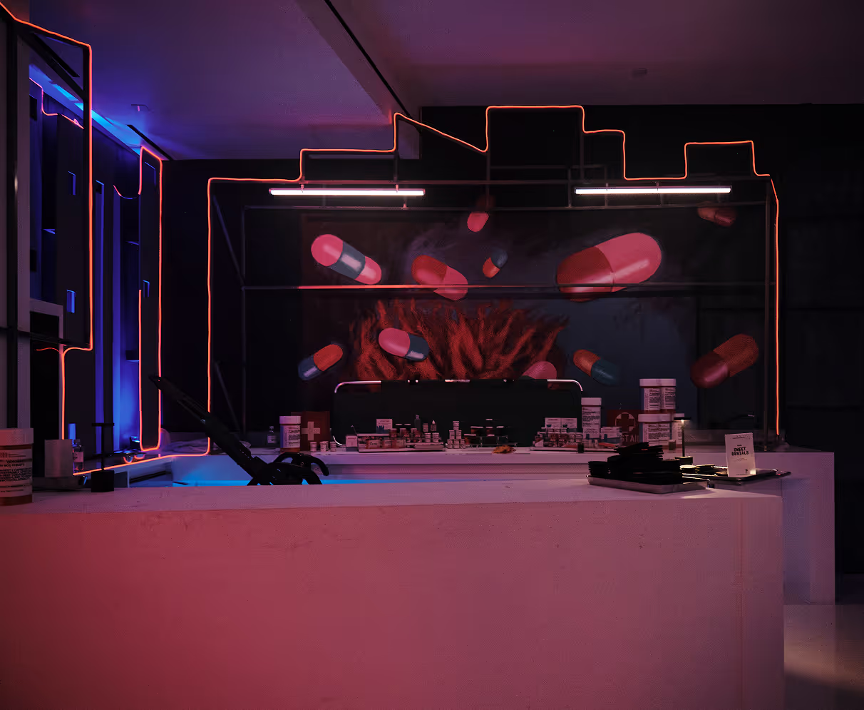A room with a counter and neon lights.
