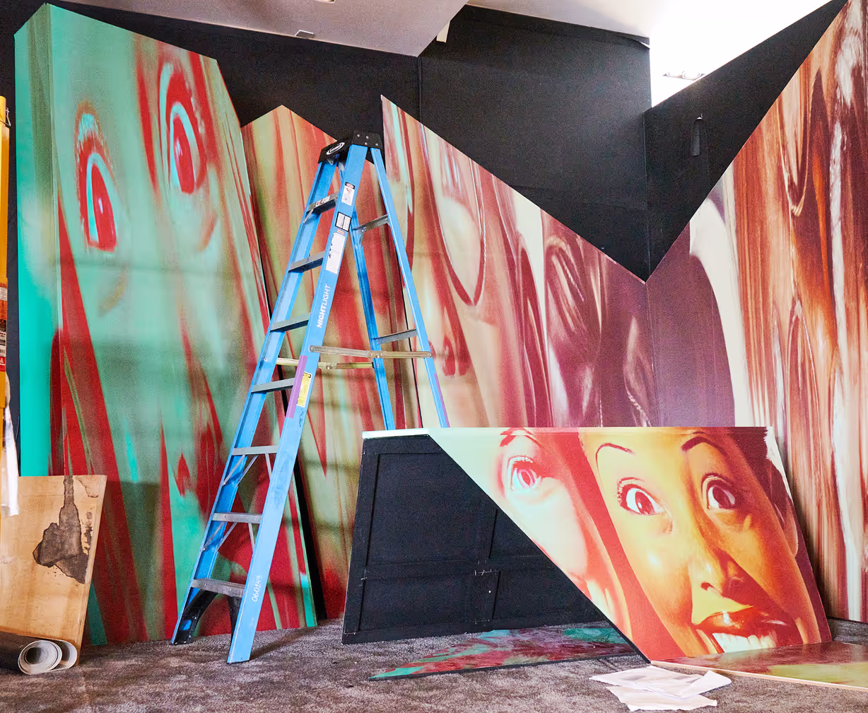 A painting of a woman is being painted on a wall.
