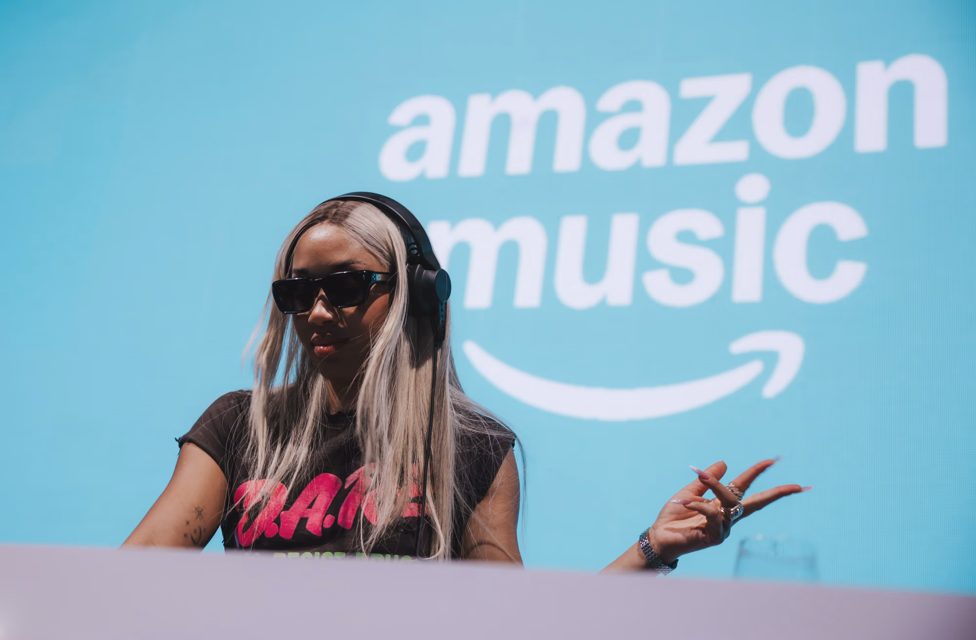 A woman with long hair wearing headphones and a t - shirt.