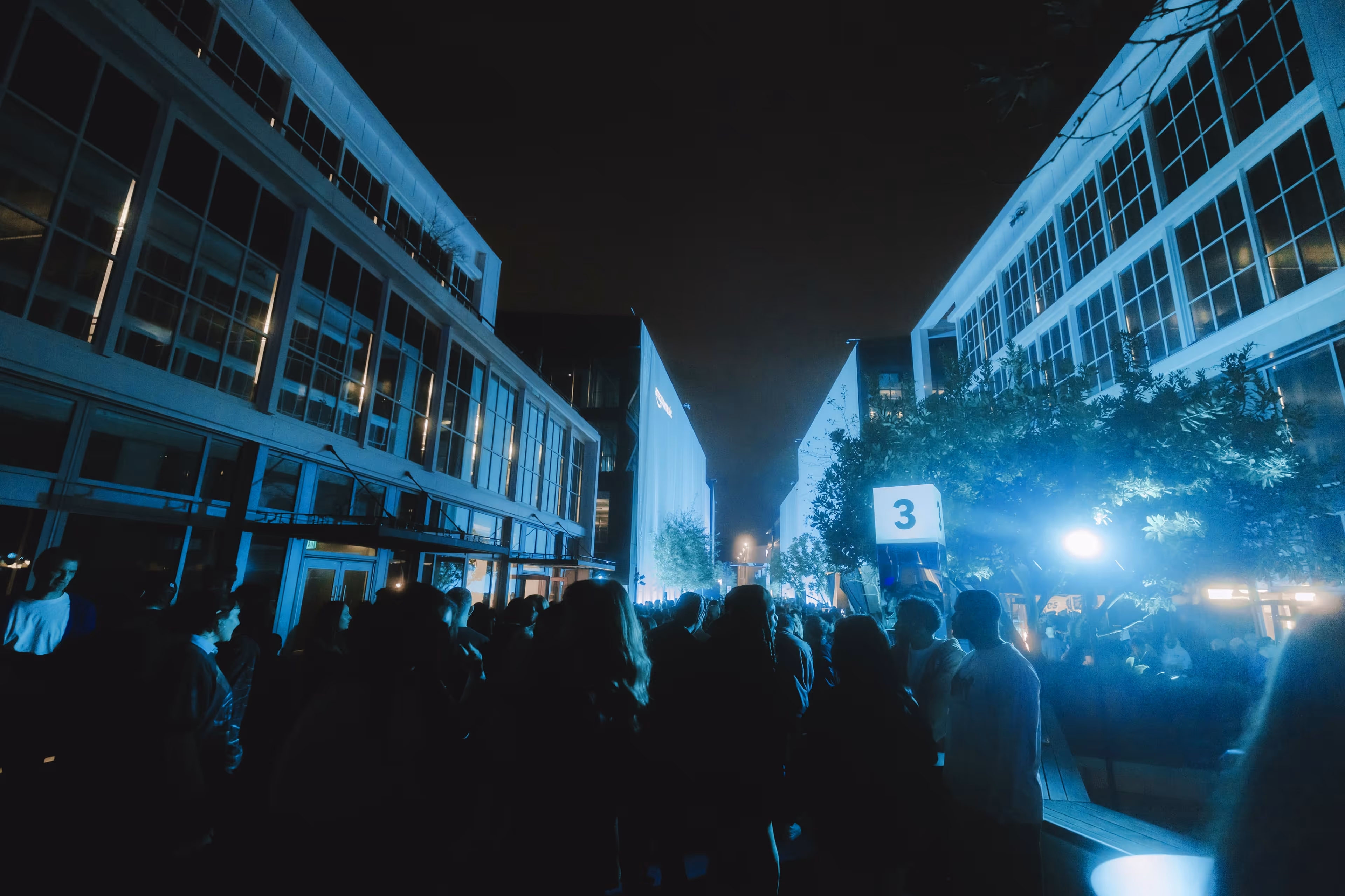 A group of people standing in the middle of a street.