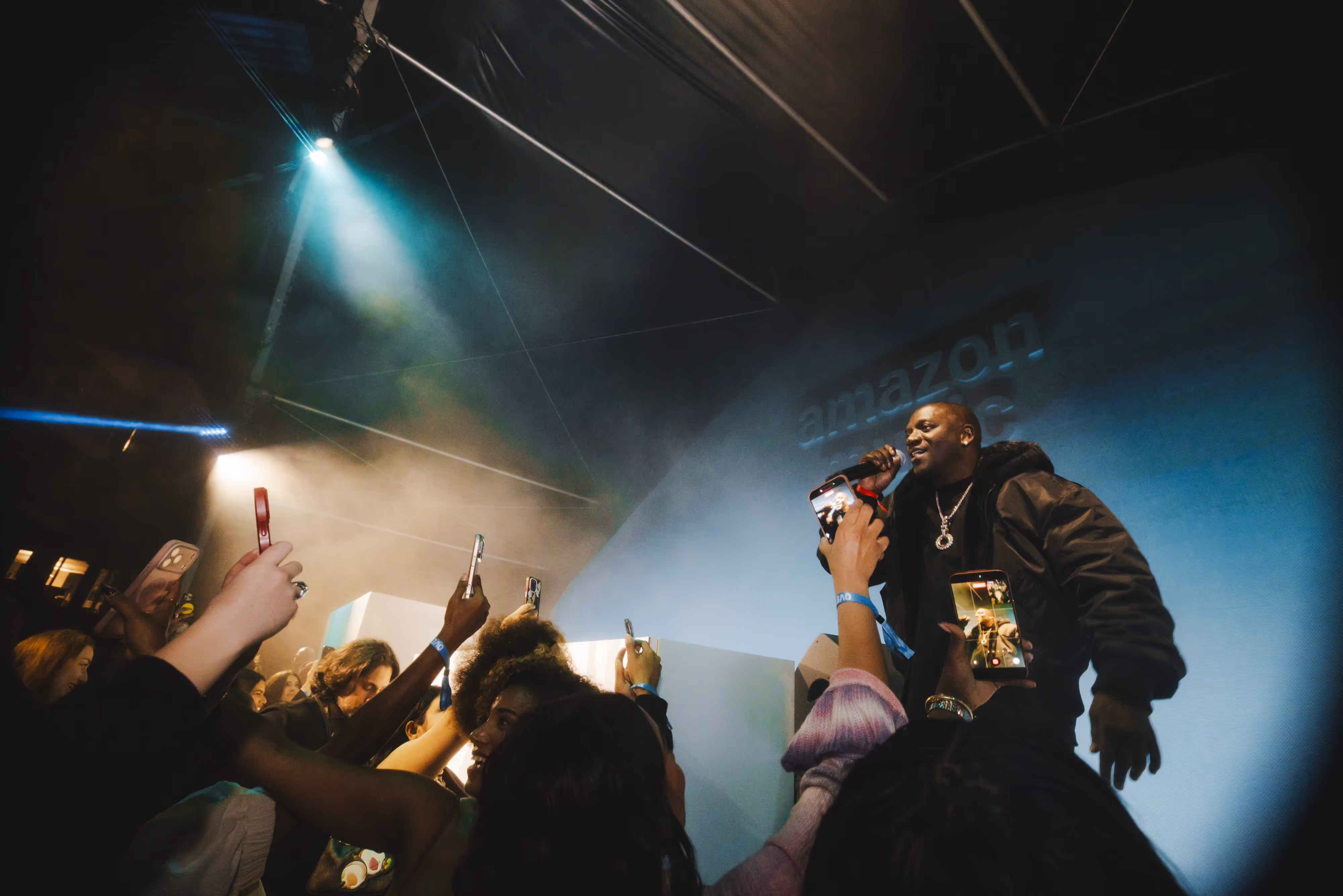 A man standing on a stage holding a microphone.