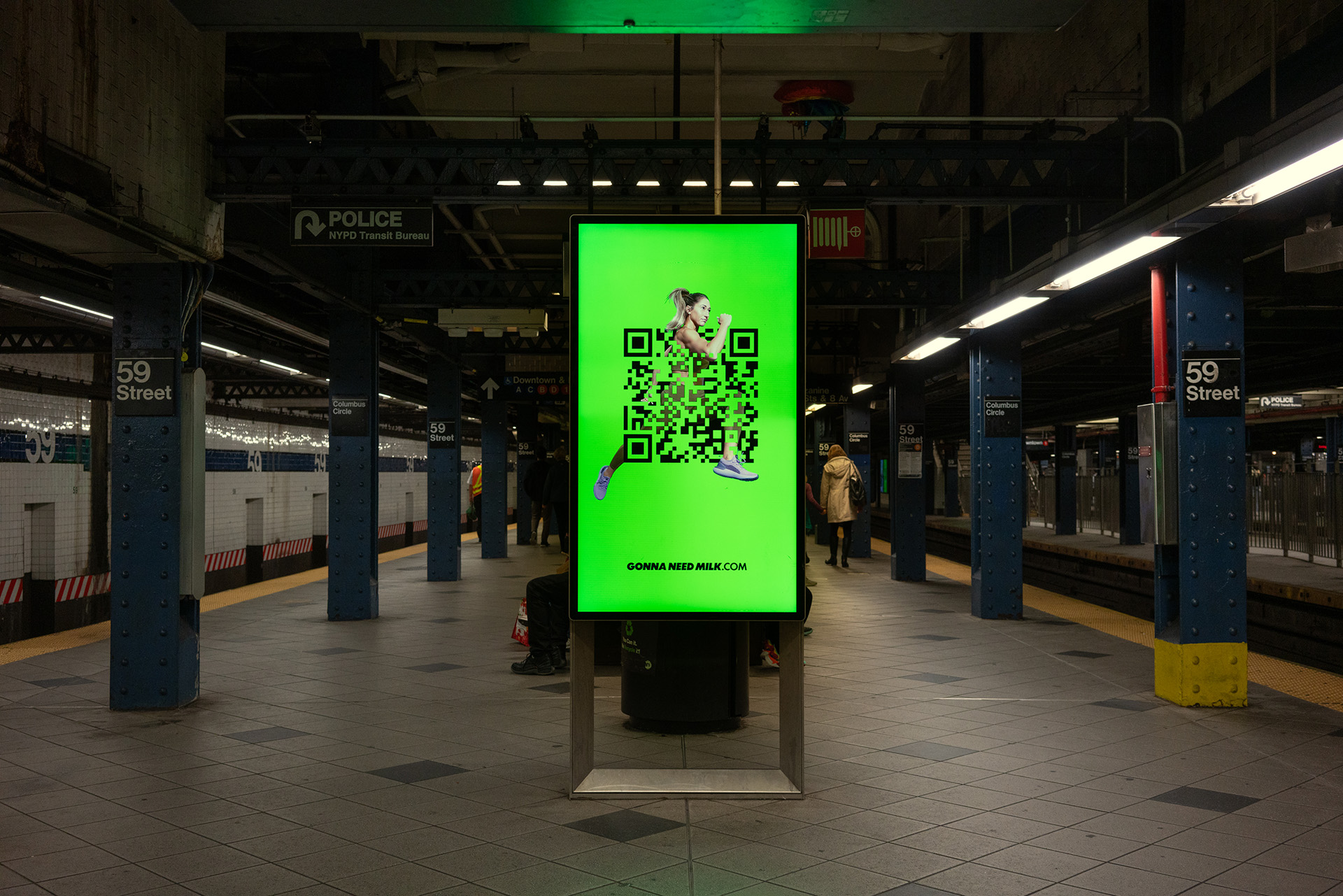 A digital Sign on a New York City subway platform depicting a woman runner and a QR code
