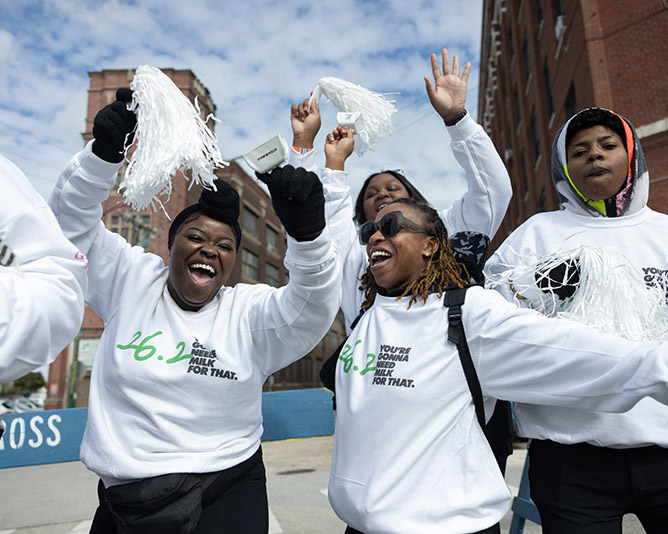 A group of women celebrate their completion of the Every Woman's Marathon