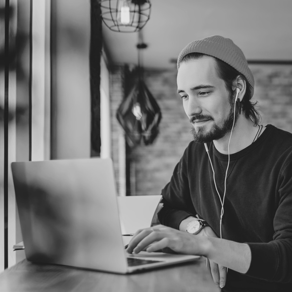 Young man listening to music on laptop