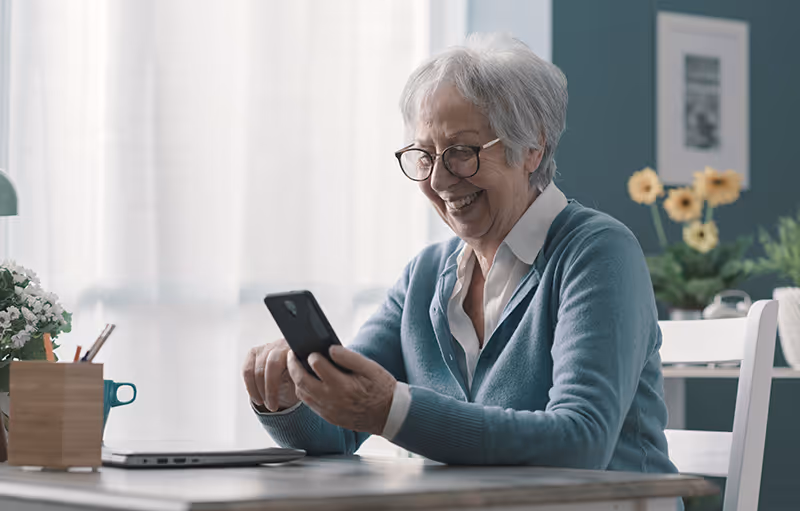 Image of an elderly woman communicating with her doctor via a secure patient texting solution