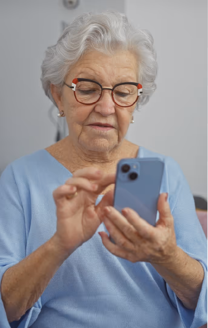 Senior woman using an iphone to fill out a form.
