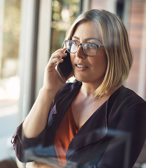 A female patient interacting with QliqAGENT via phone