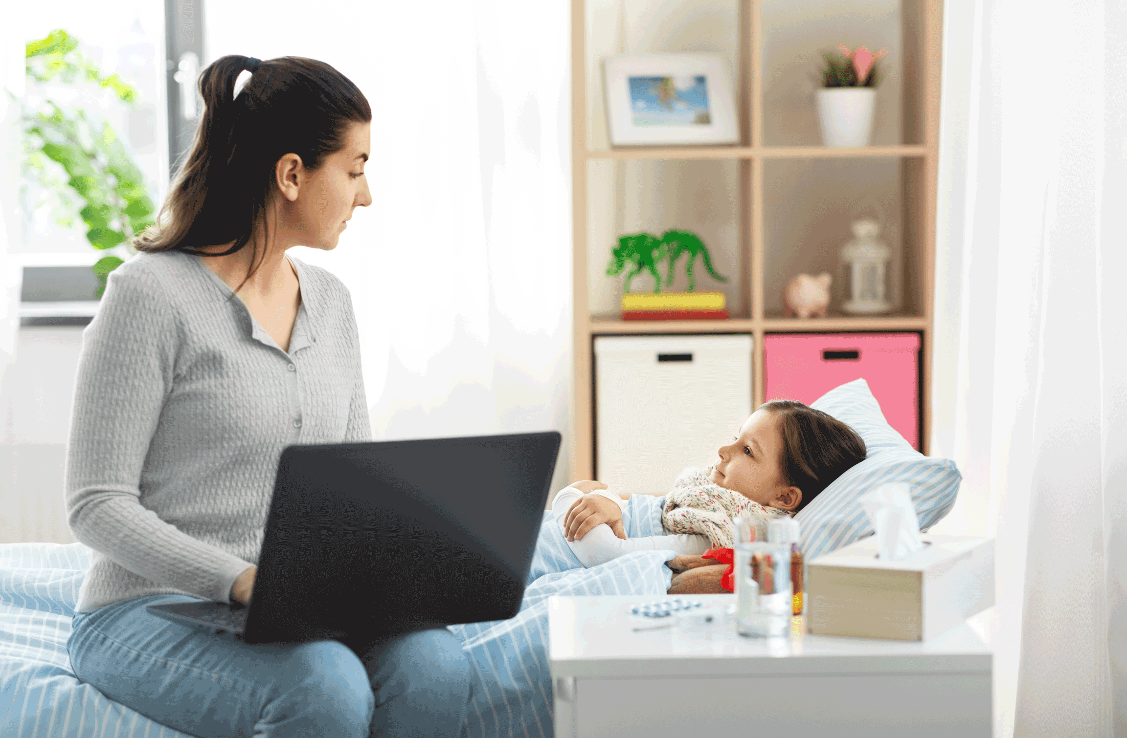 Mother Searching for care of child on laptop