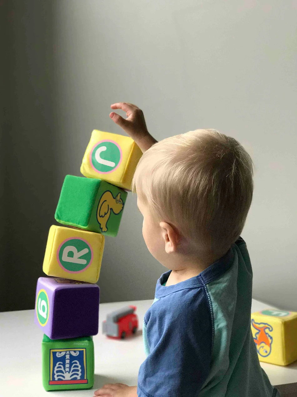 A child playing with a tower of blocks
