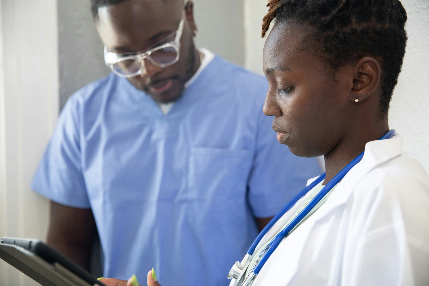 Two doctors looking at the tablet