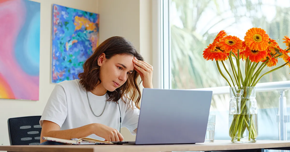 Exhausted professional experiencing burnout symptoms while working late at a desk