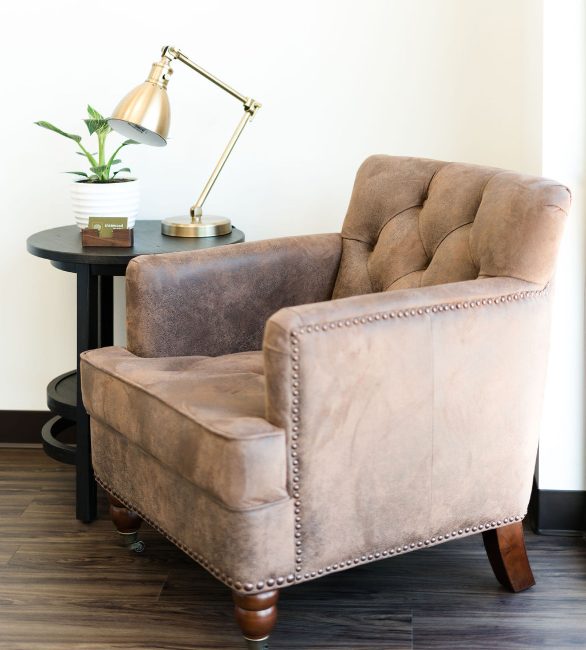 an accent chair with a side table