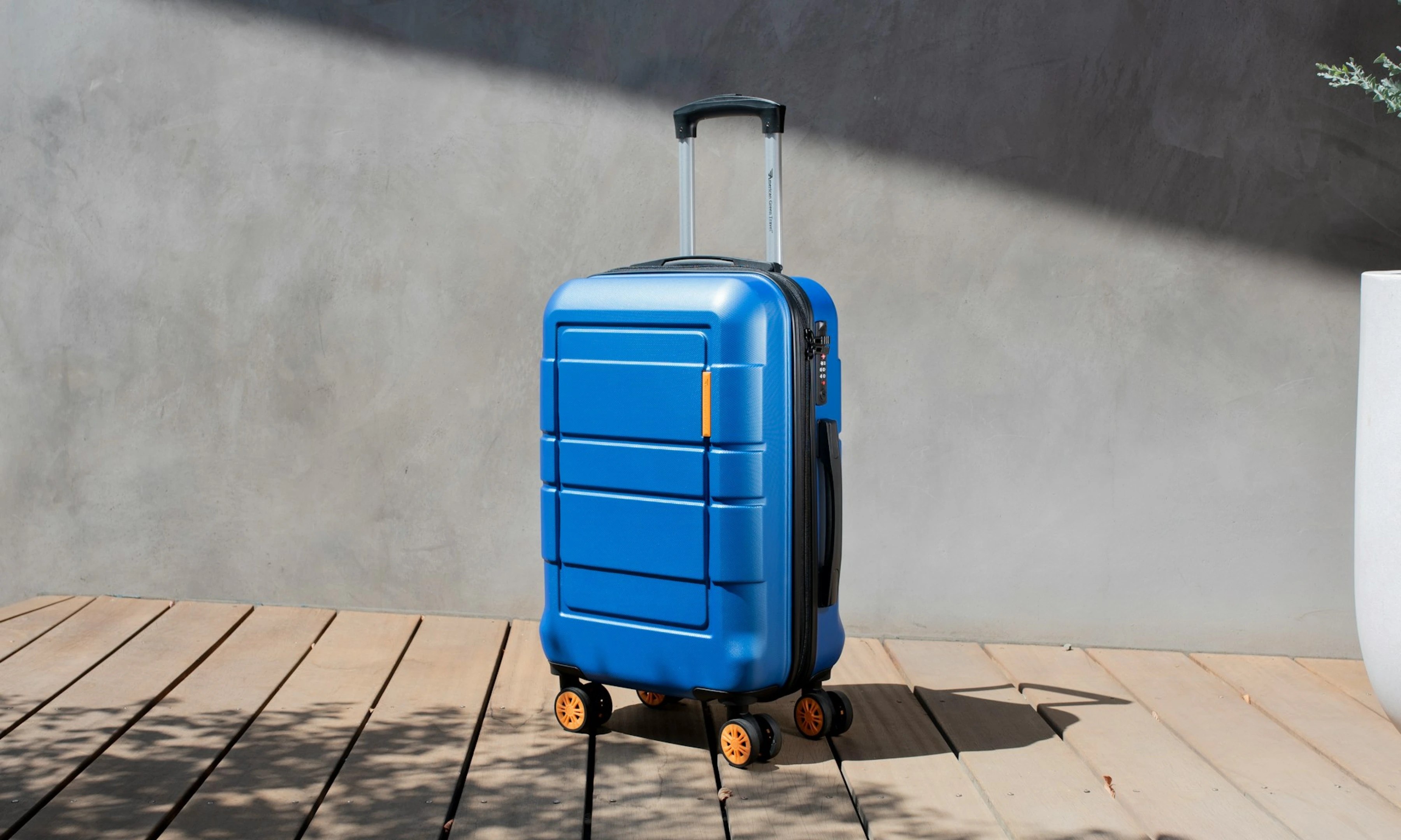 A small, blue carry-on suitcase.