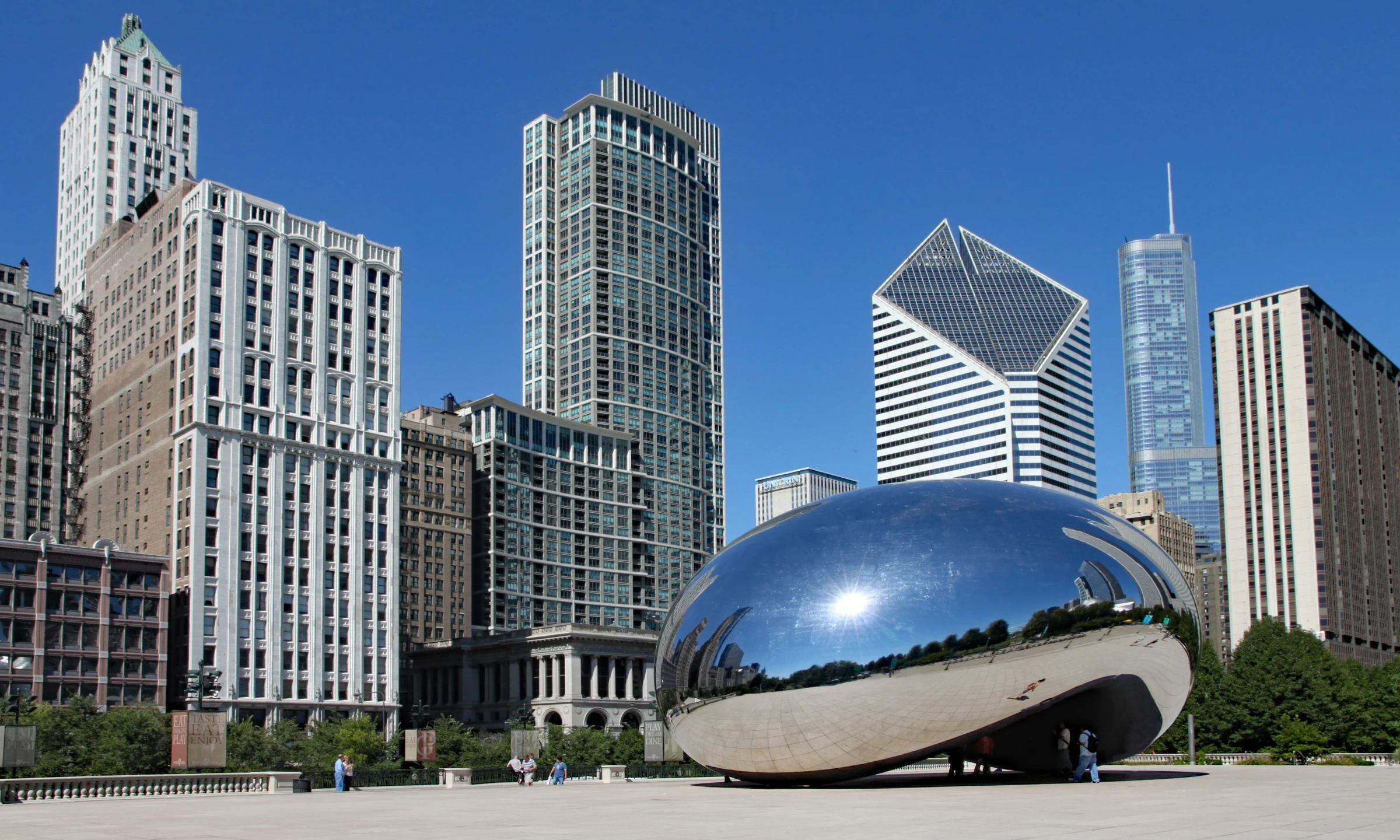 Cloud Gate sculpture, also known as "The Bean," in Chicago's Millennium Park reflects the surrounding skyline in its polished, mirror-like surface. This is one of the top things to do on a layover in Chicago.