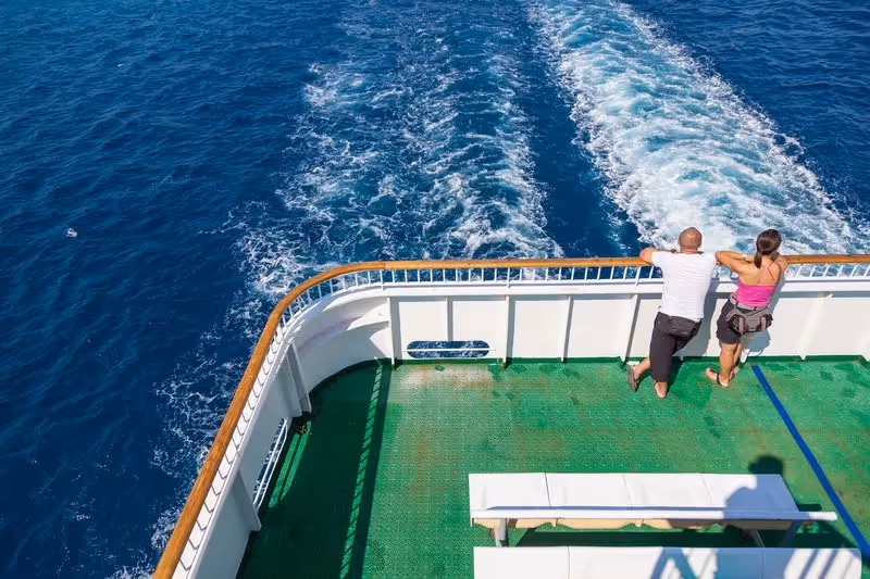 Traversée en ferry entre Split et Bol, avec deux voyageurs admirant le sillage en mer Adriatique.