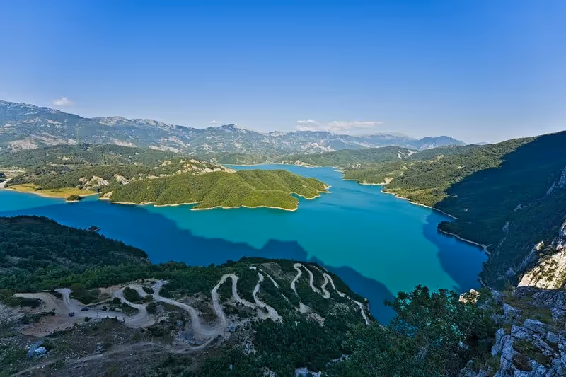 	Vue panoramique sur le lac Bovilla entouré de montagnes