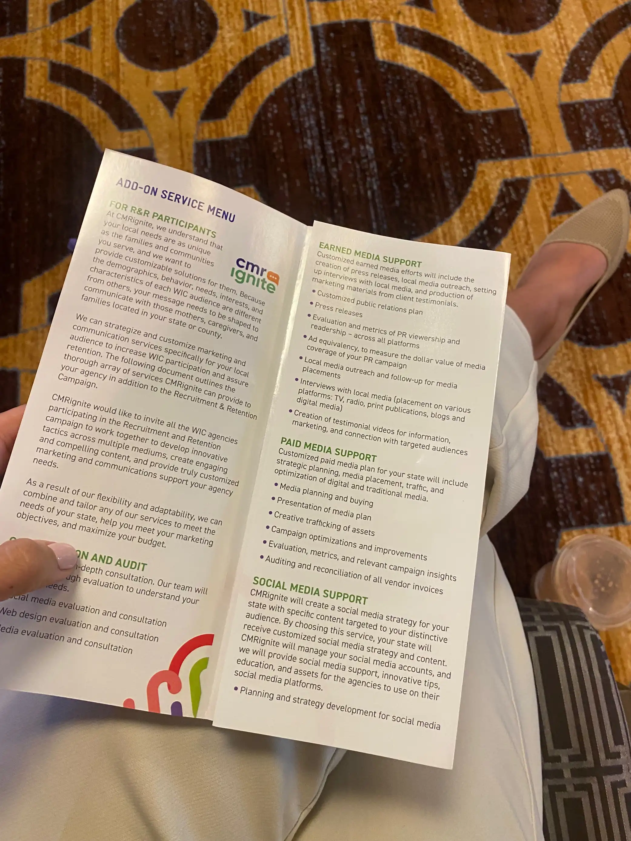 somebody's hand with a brochure at a conference