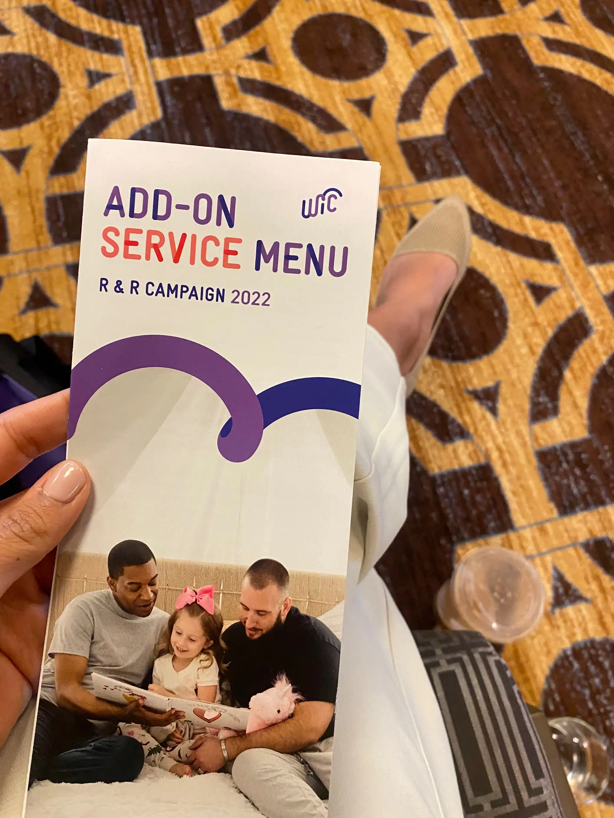 somebody's hand with a brochure at a conference