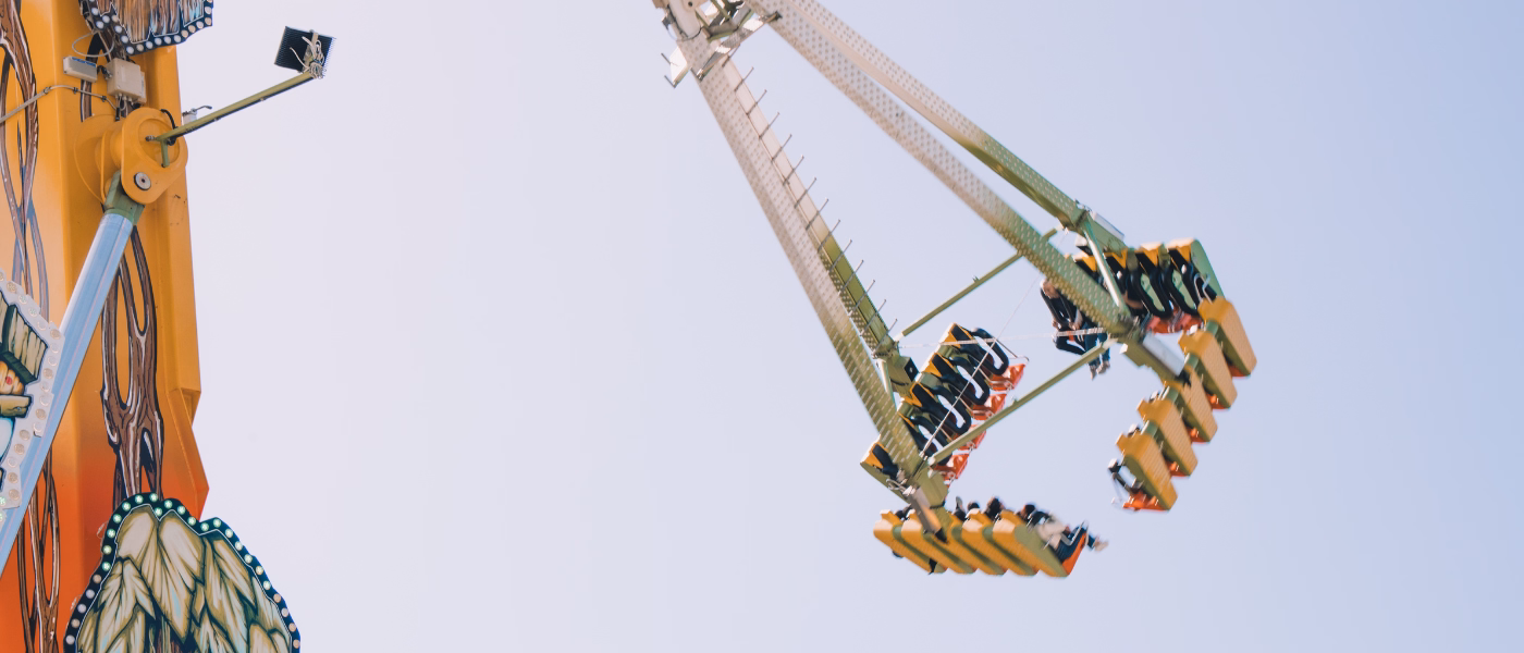 Amusement park ride swinging high in the air, illustrating rapid head movements and spinning sensations associated with benign paroxysmal positional vertigo (BPPV).