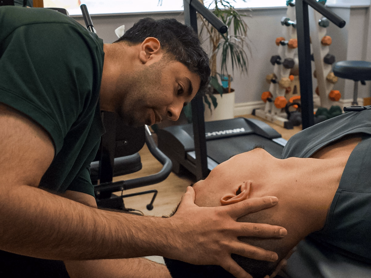 Physiotherapist performing vestibular rehabilitation therapy for a patient with labyrinthitis or vestibular neuritis in a clinical setting