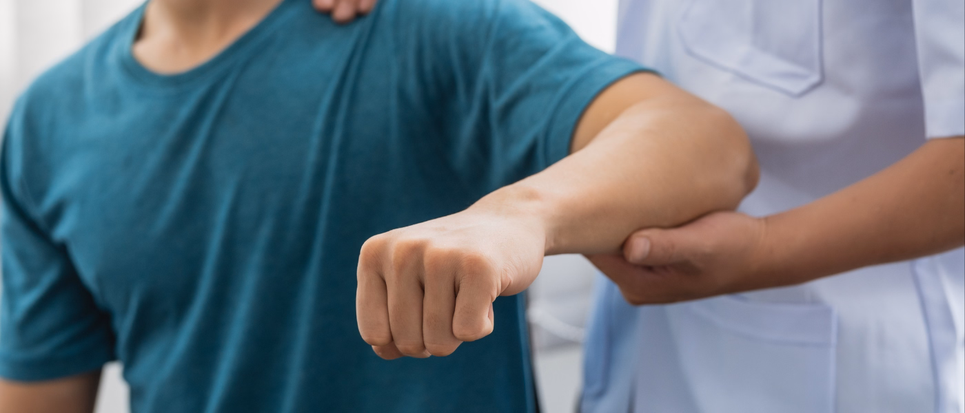 Physical therapist supporting patient's arm during rehabilitation for Radial Tunnel Syndrome, focusing on forearm and elbow pain relief.