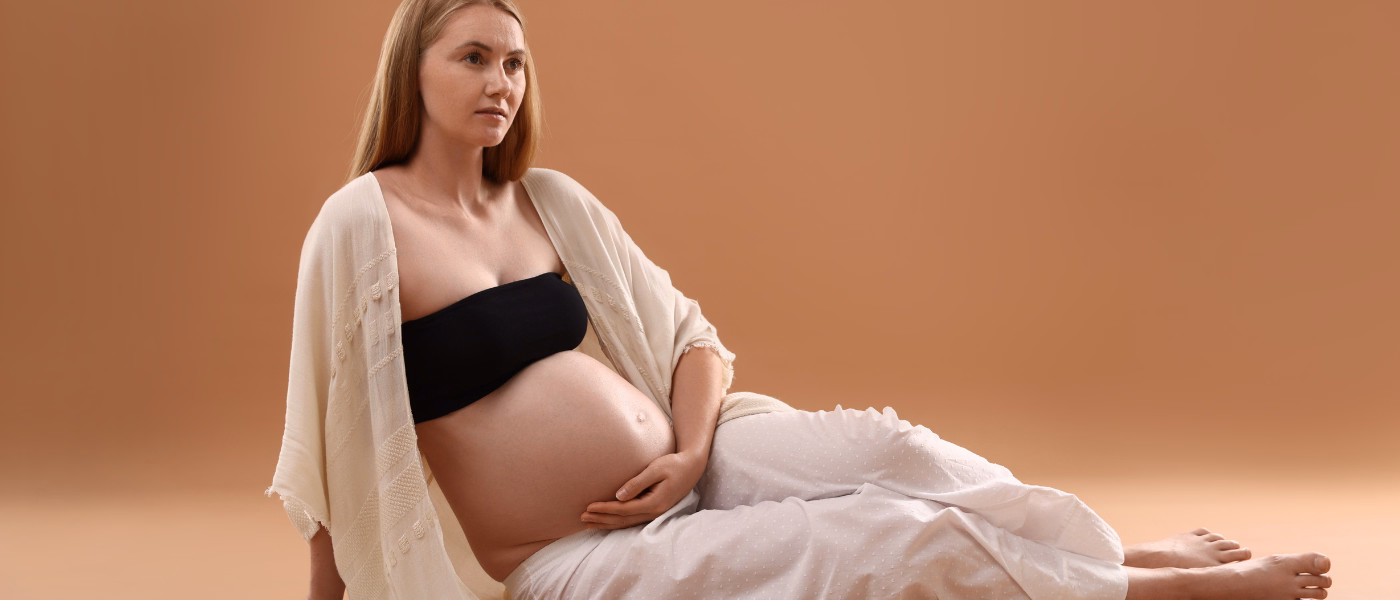 Woman holding abdomen illustrating caesarean section recovery rehabilitation and postpartum healing
