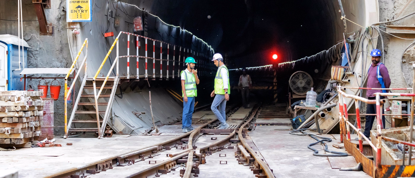 Construction workers standing on site representing occupational risk for patellar bursitis
