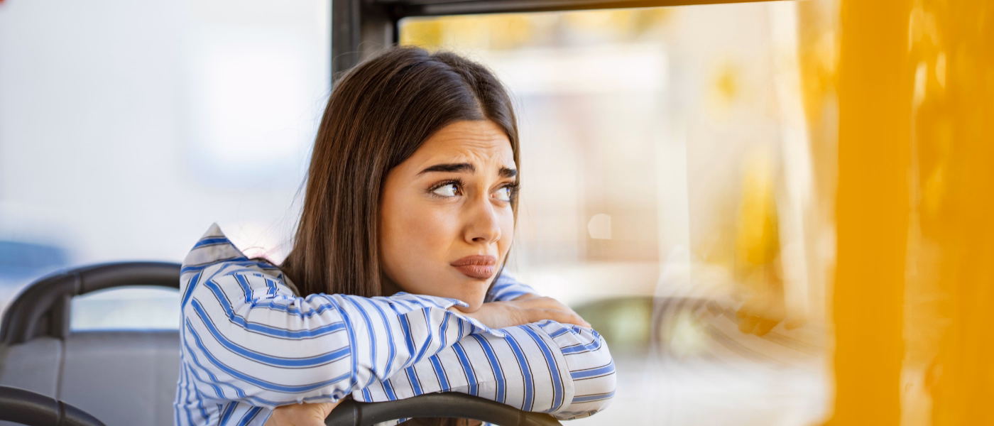 Woman appearing uncomfortable illustrating urinary urgency and frequency symptoms