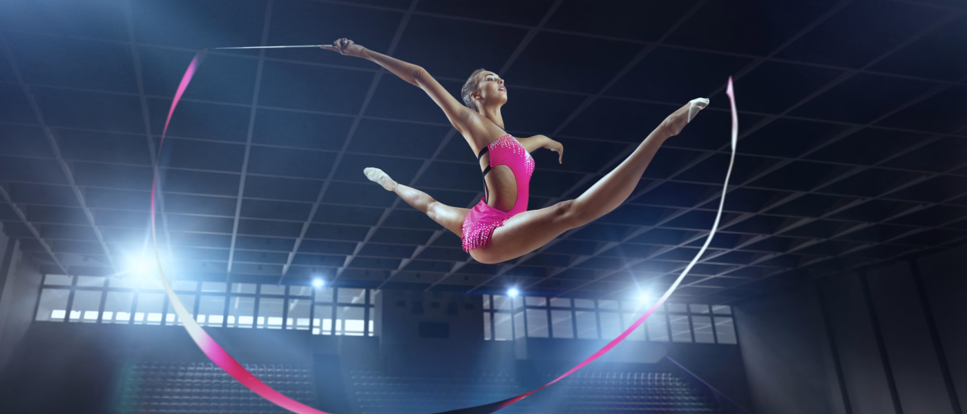 Hypermobile gymnast mid-jump showing joint flexibility, representing hypermobility and Ehlers-Danlos physiotherapy