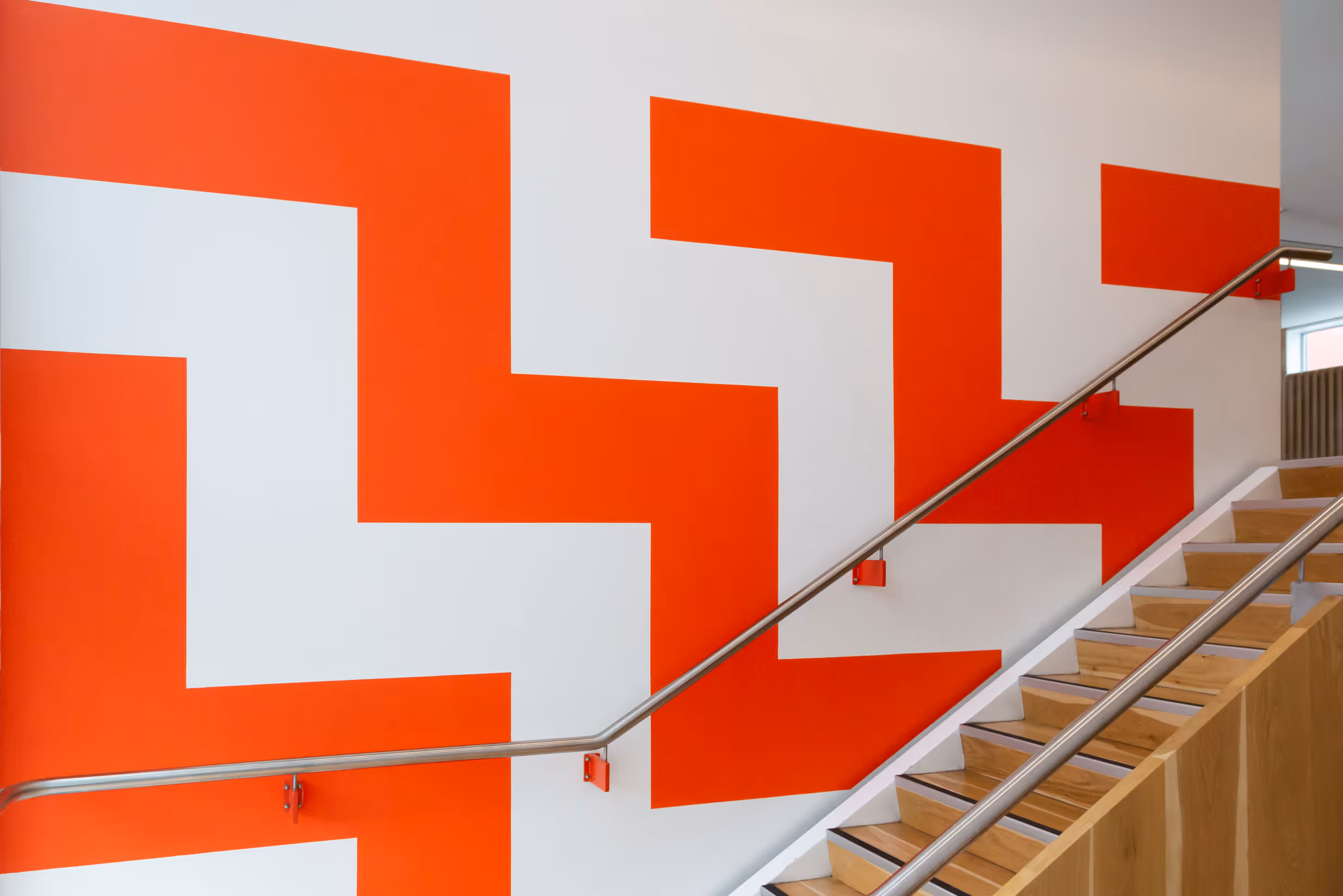 Auckland Council community centre stairwell wall graphic with bold orange geometric pattern, designed, fabricated and installed by Blink, Auckland