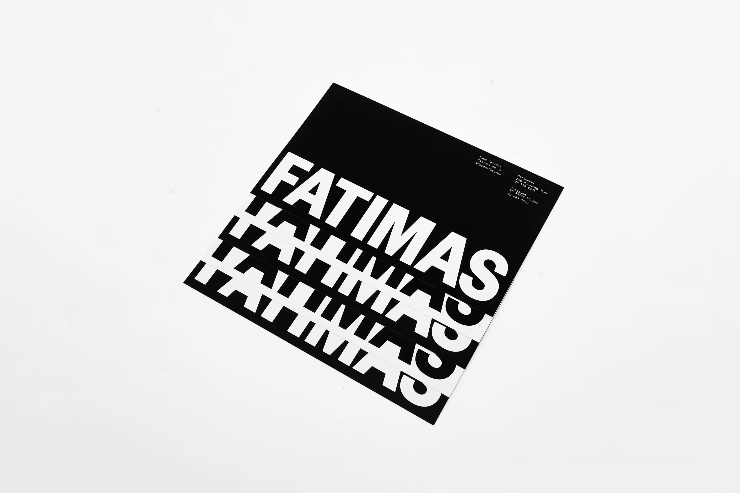 Stack of Fatima's printed brand collateral featuring bold typography by Blink