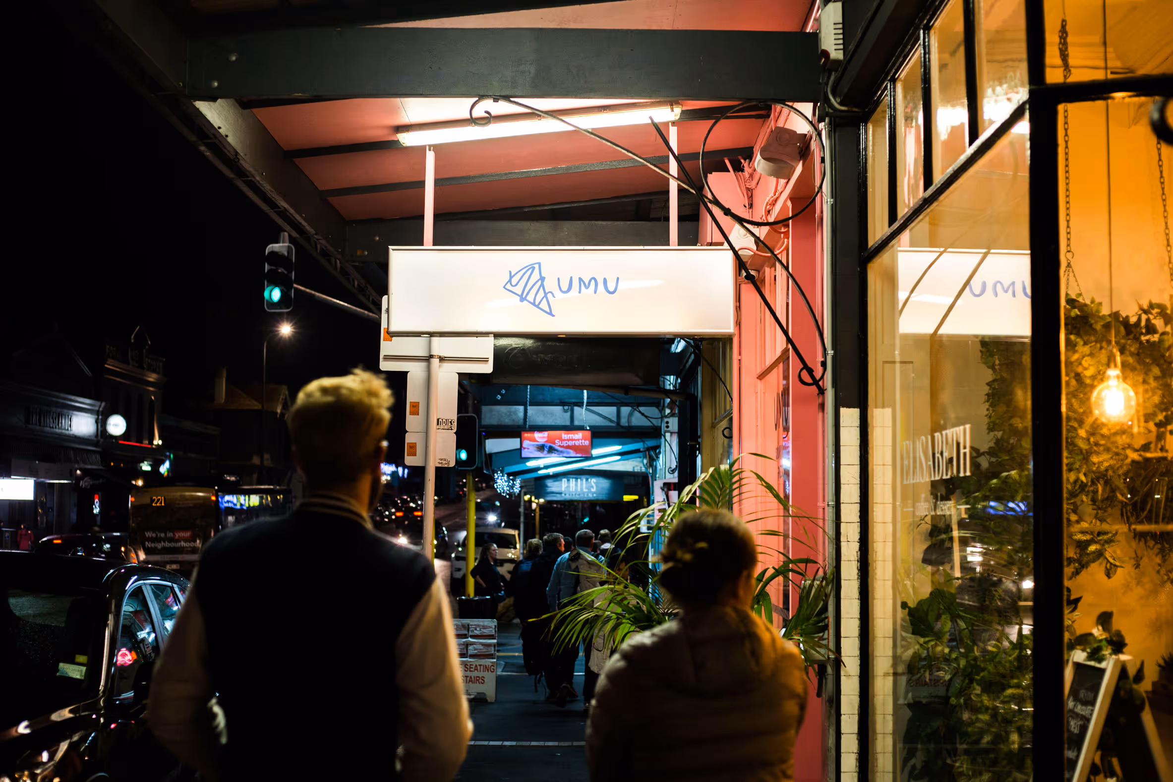 Umu Pizza exterior lightbox signage and pink shopfront in Kingsland at night, designed, fabricated and installed by Blink, Auckland